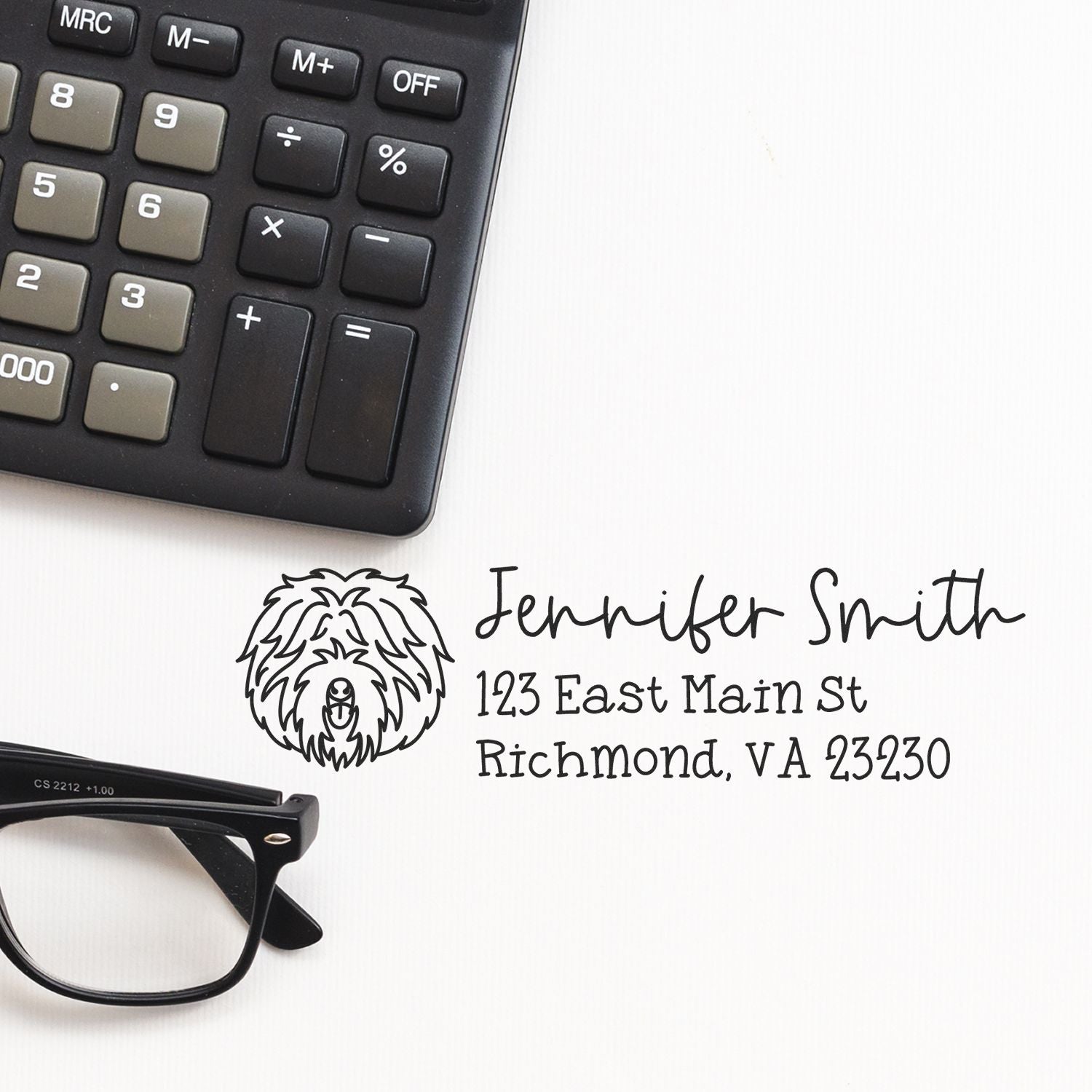Personalized return address rubber stamp with dog logo, Jennifer Smith name, and Richmond VA address beside calculator and glasses.