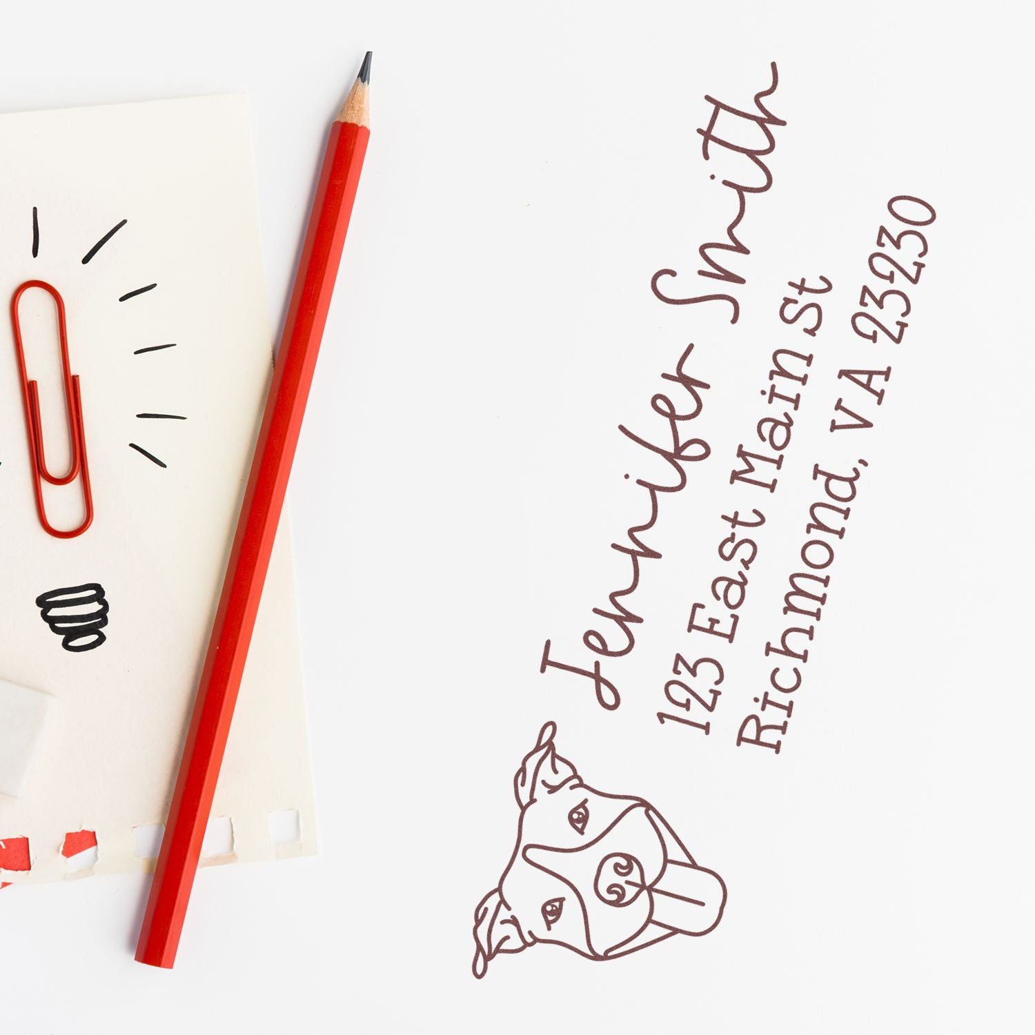 Custom return address rubber stamp with dog illustration for Jennifer Smith, 123 East Main St, Richmond, VA 23230.