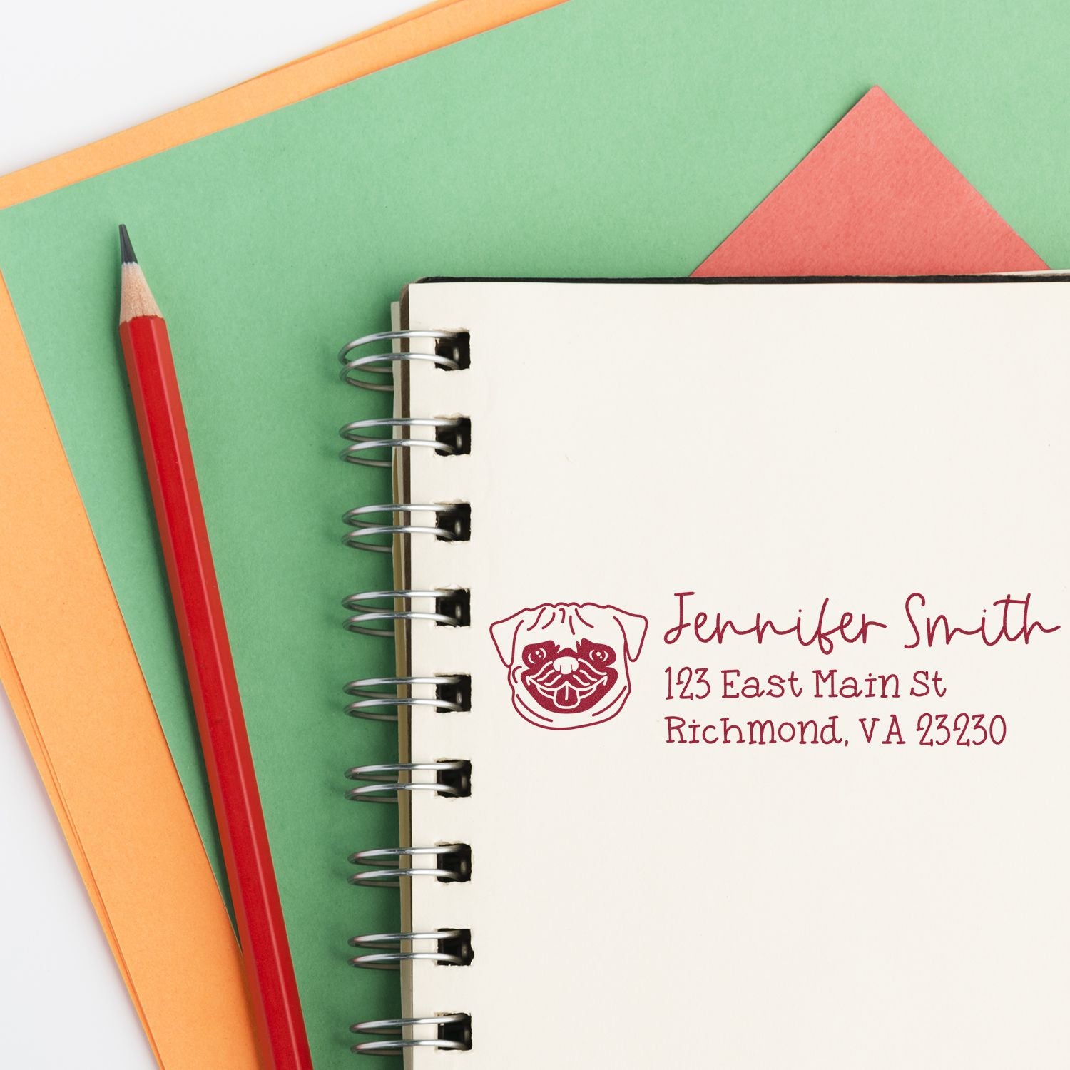 Personalized rubber return address stamp with dog icon on notebook, showing name and Richmond, VA mailing details.