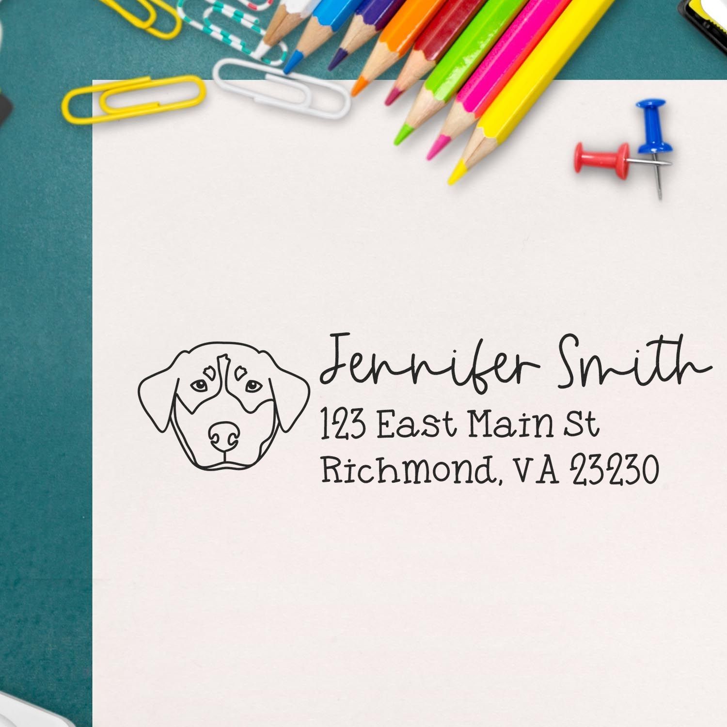 Custom dog address rubber stamp with name and Richmond, VA address on paper, shown with pencils and stationery.