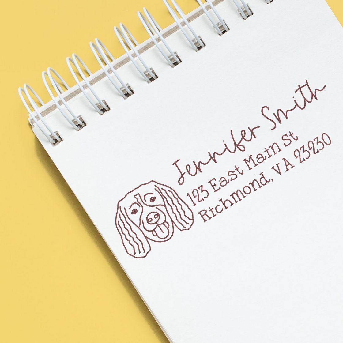 Custom dog return address rubber stamp impression on notebook, featuring Jennifer Smith name and address for personalized mailing.