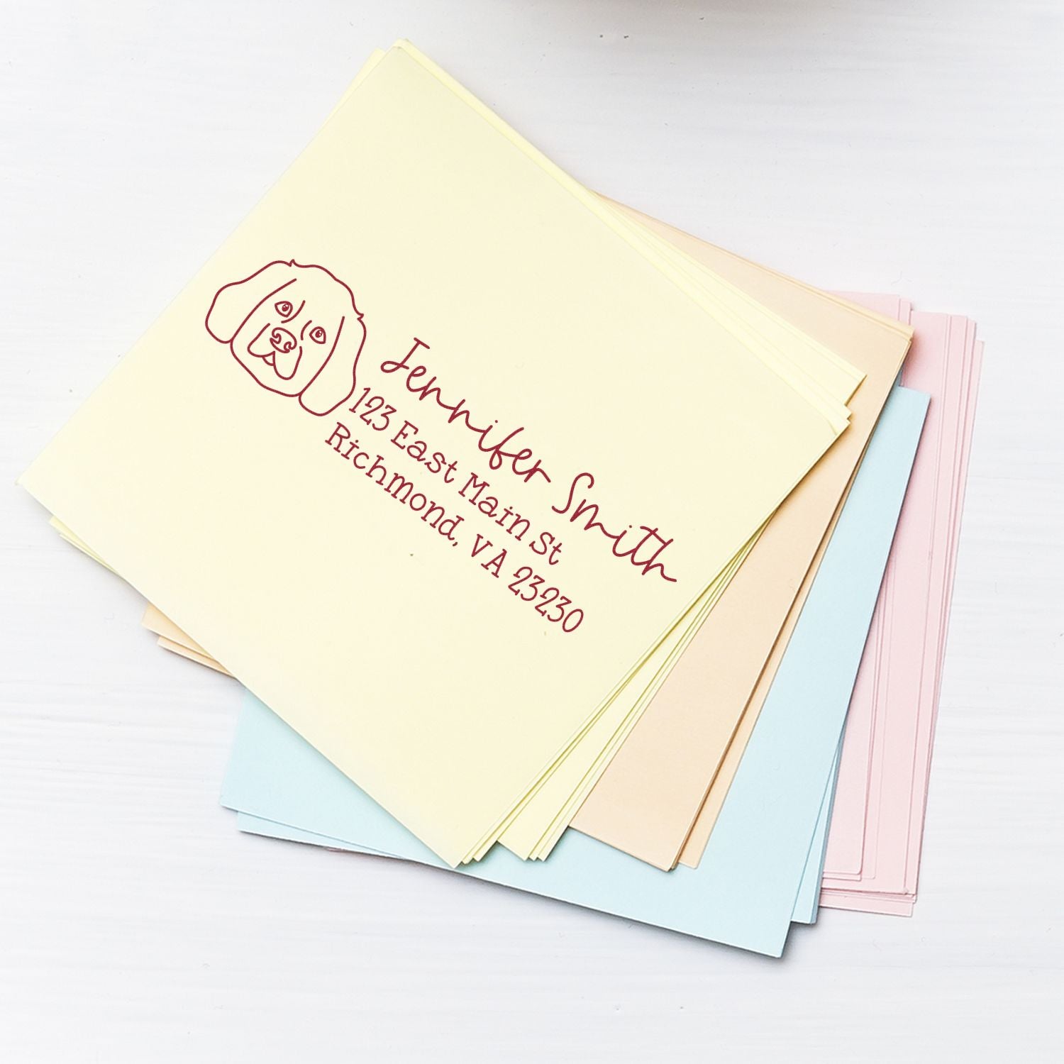 Custom return address rubber stamp with dog design on pastel envelopes for pet lover mail and stationery.