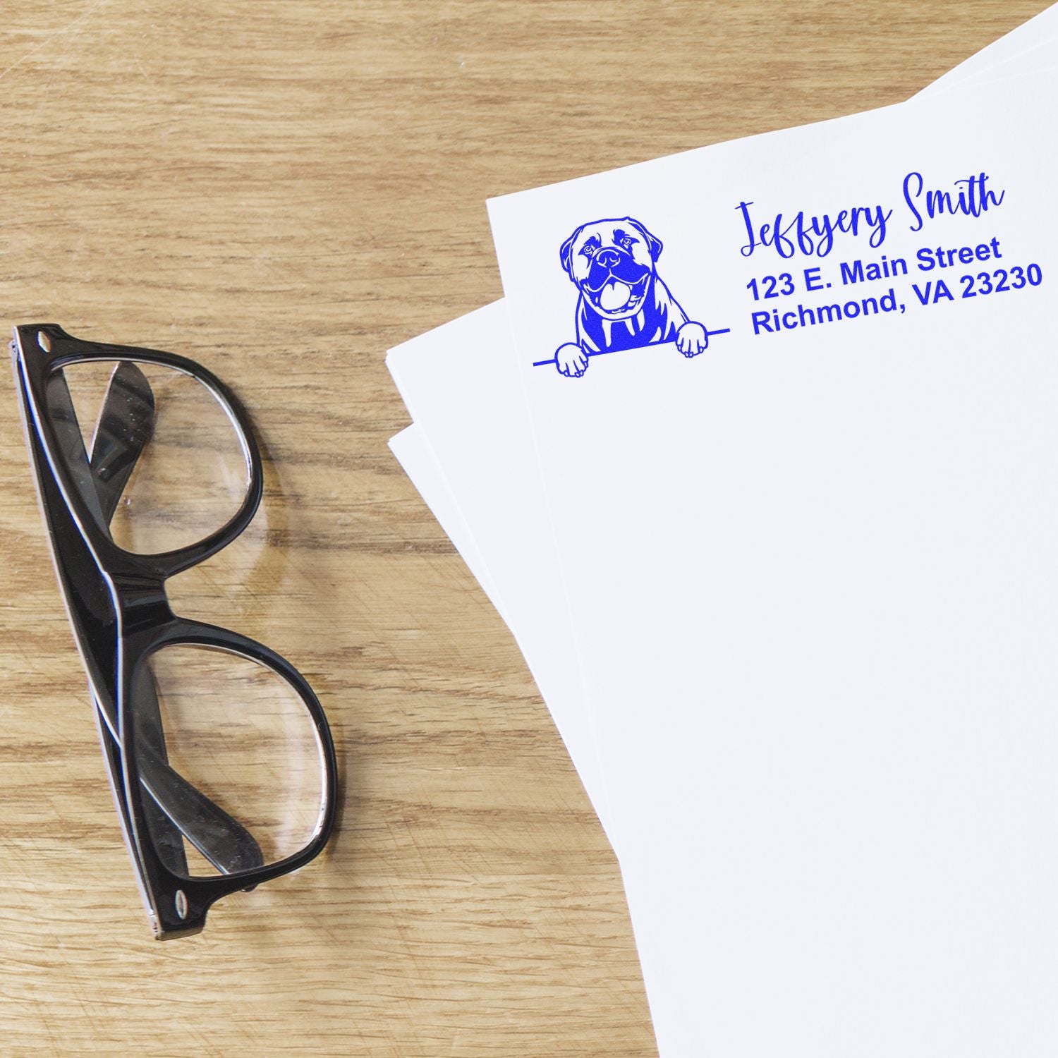 Custom rubber address stamp with dog logo and Richmond, VA return address printed in blue on white paper.