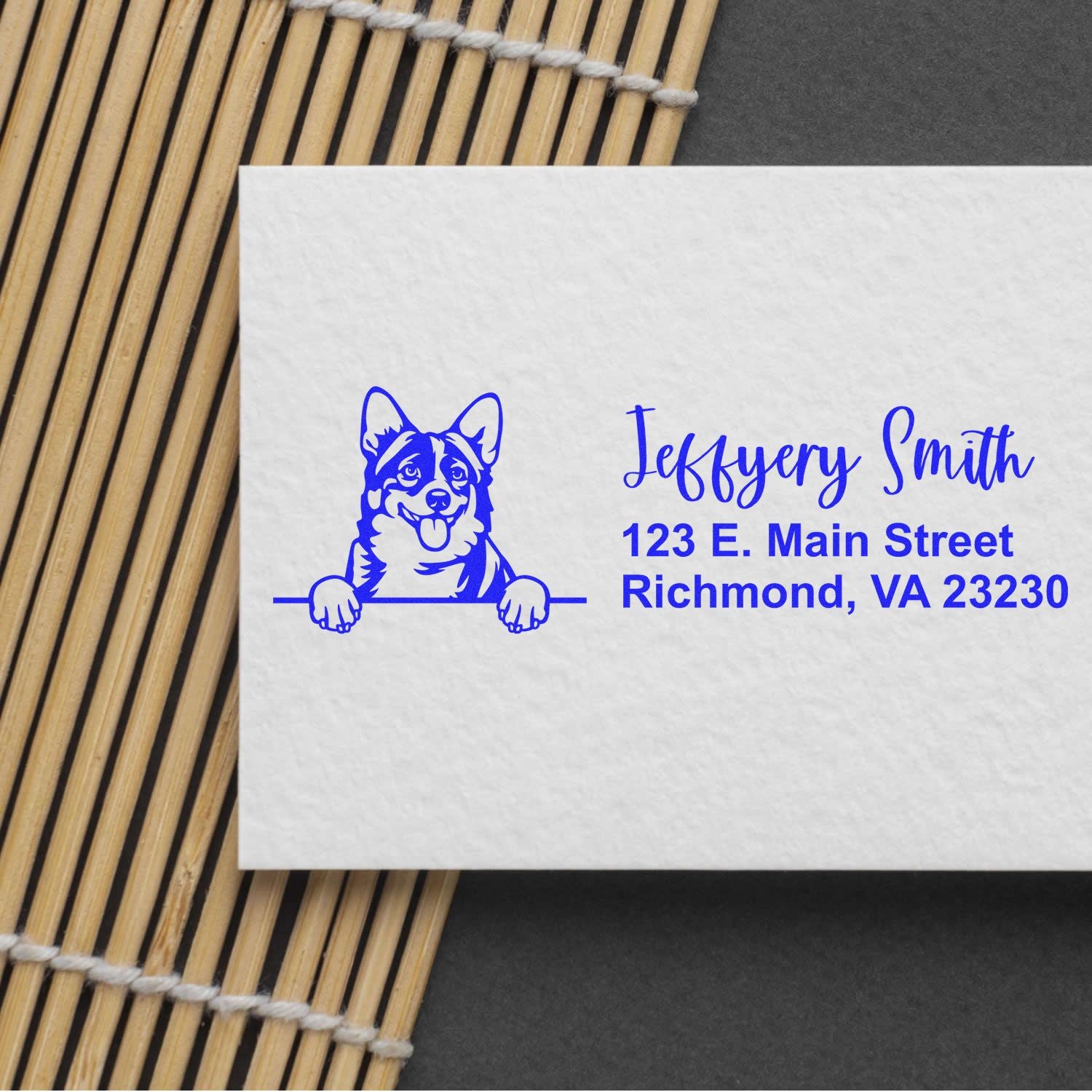 Personalized rubber address stamp with corgi logo on envelope, featuring name and Richmond, VA address.