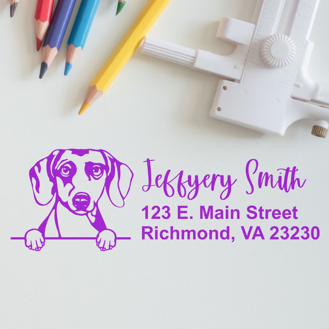 Custom dog-themed rubber return address stamp for Jeffery Smith, Richmond VA, shown with pencils and stamp tool.