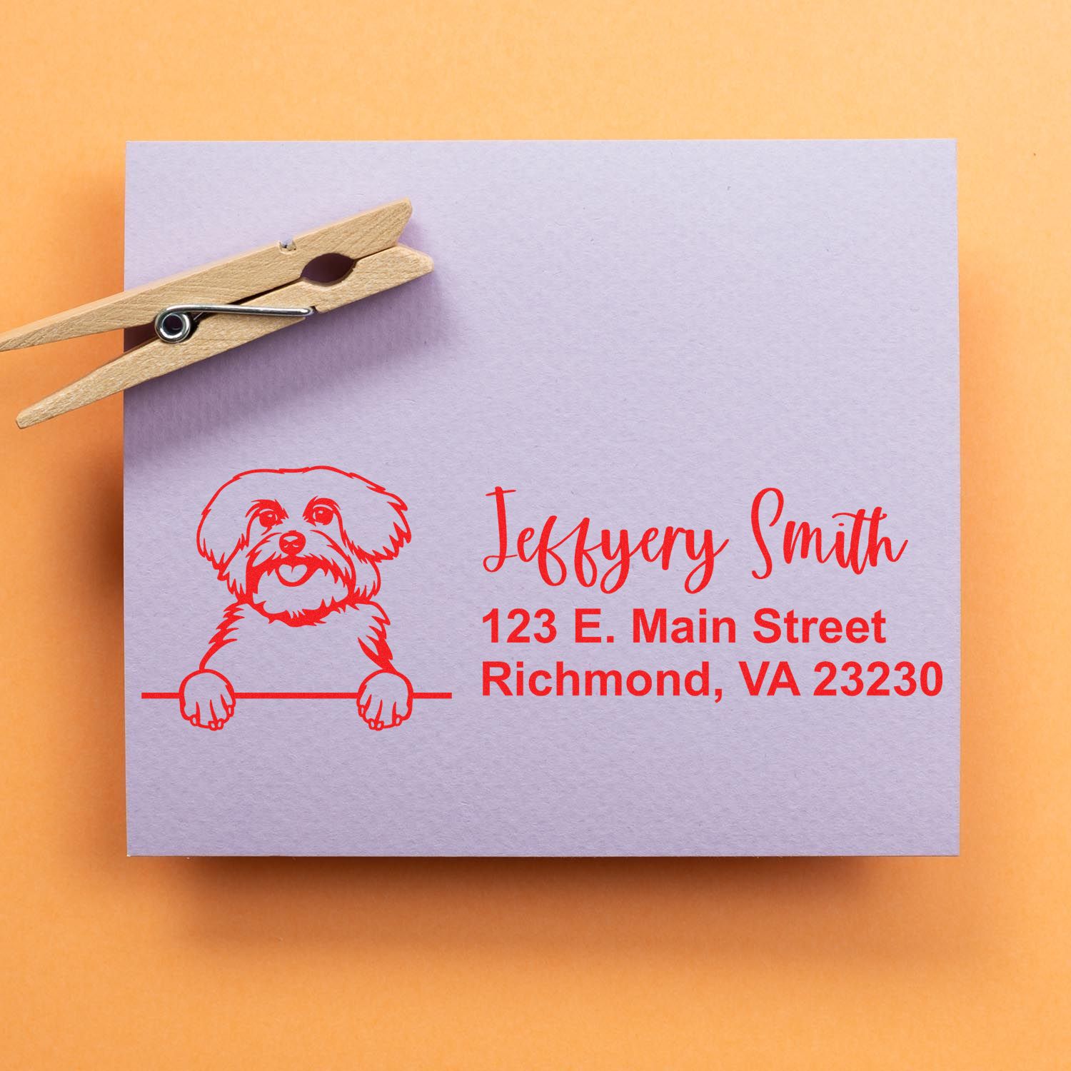 Custom dog return address rubber stamp on envelope, featuring a pet illustration and personalized name and address in red ink.