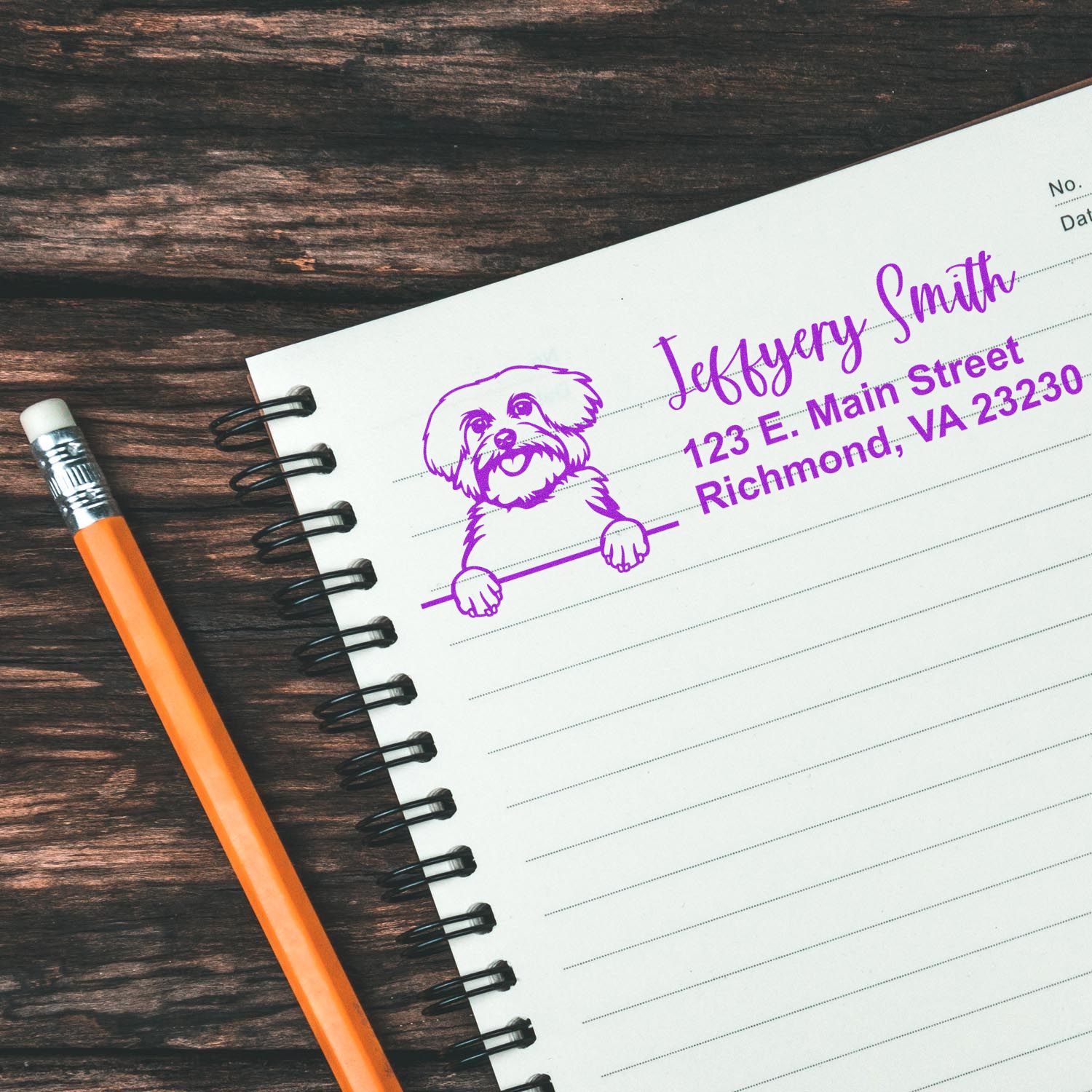 Custom dog return address rubber stamp for personalized stationery, shown on a notebook with a pencil.