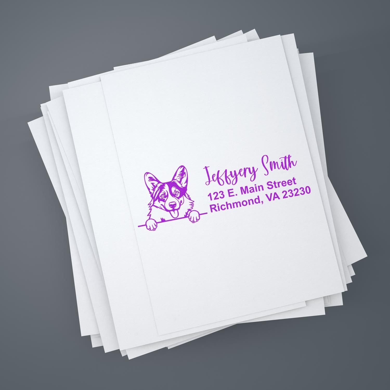 Custom dog return address rubber stamp in purple ink on stacked white paper, personalized for mailing envelopes.
