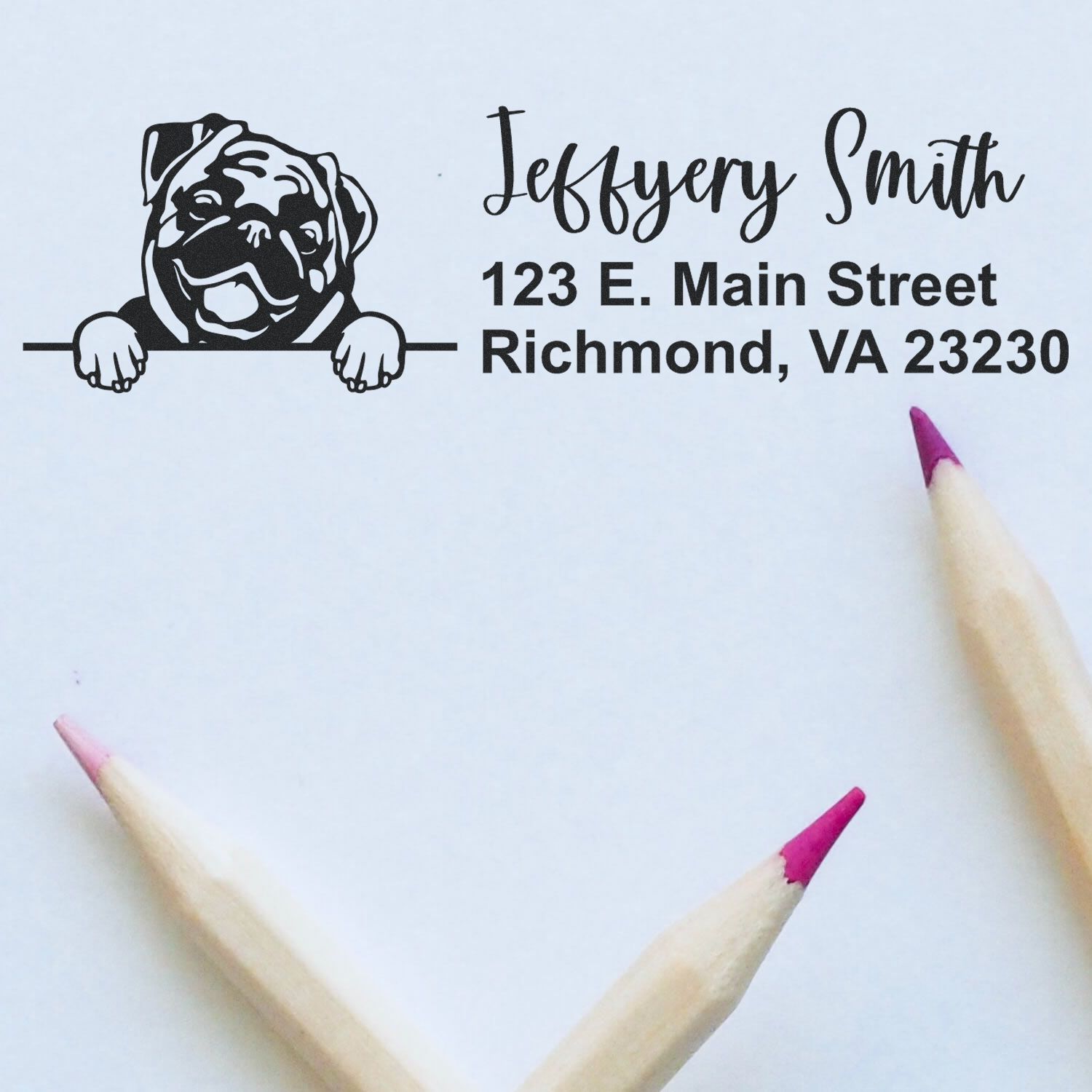 Custom bulldog return address rubber stamp with name and Richmond, VA address, shown on paper with pencils.