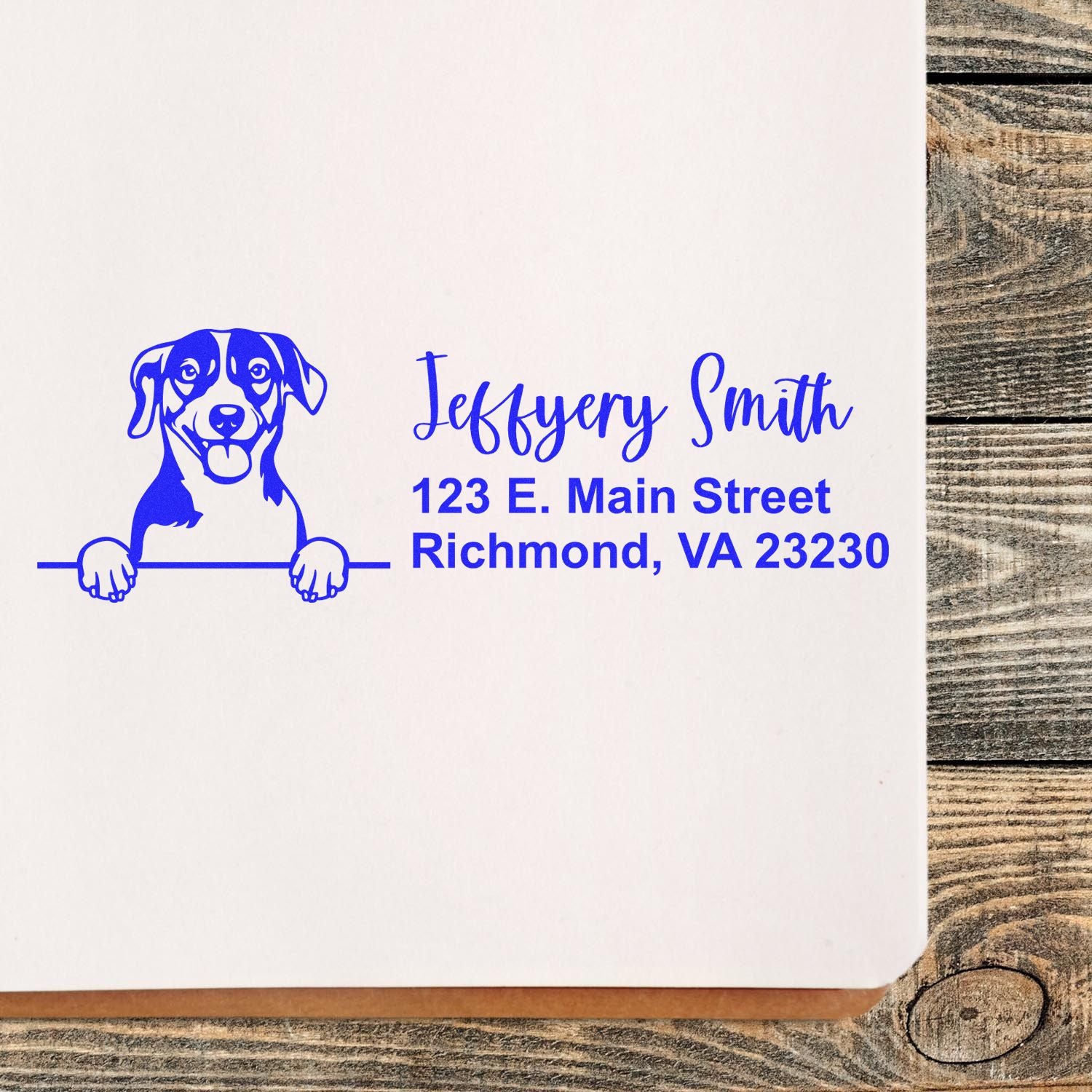 Custom dog return address rubber stamp with pet illustration, name, and mailing address in blue ink.