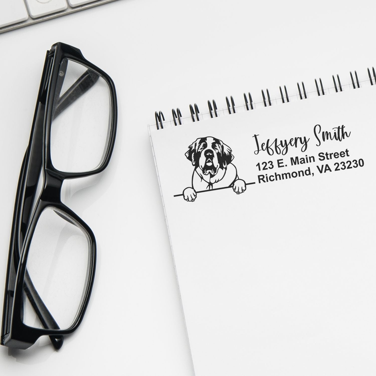Custom rubber address stamp with dog illustration and personalized name and Richmond, VA address on notepad