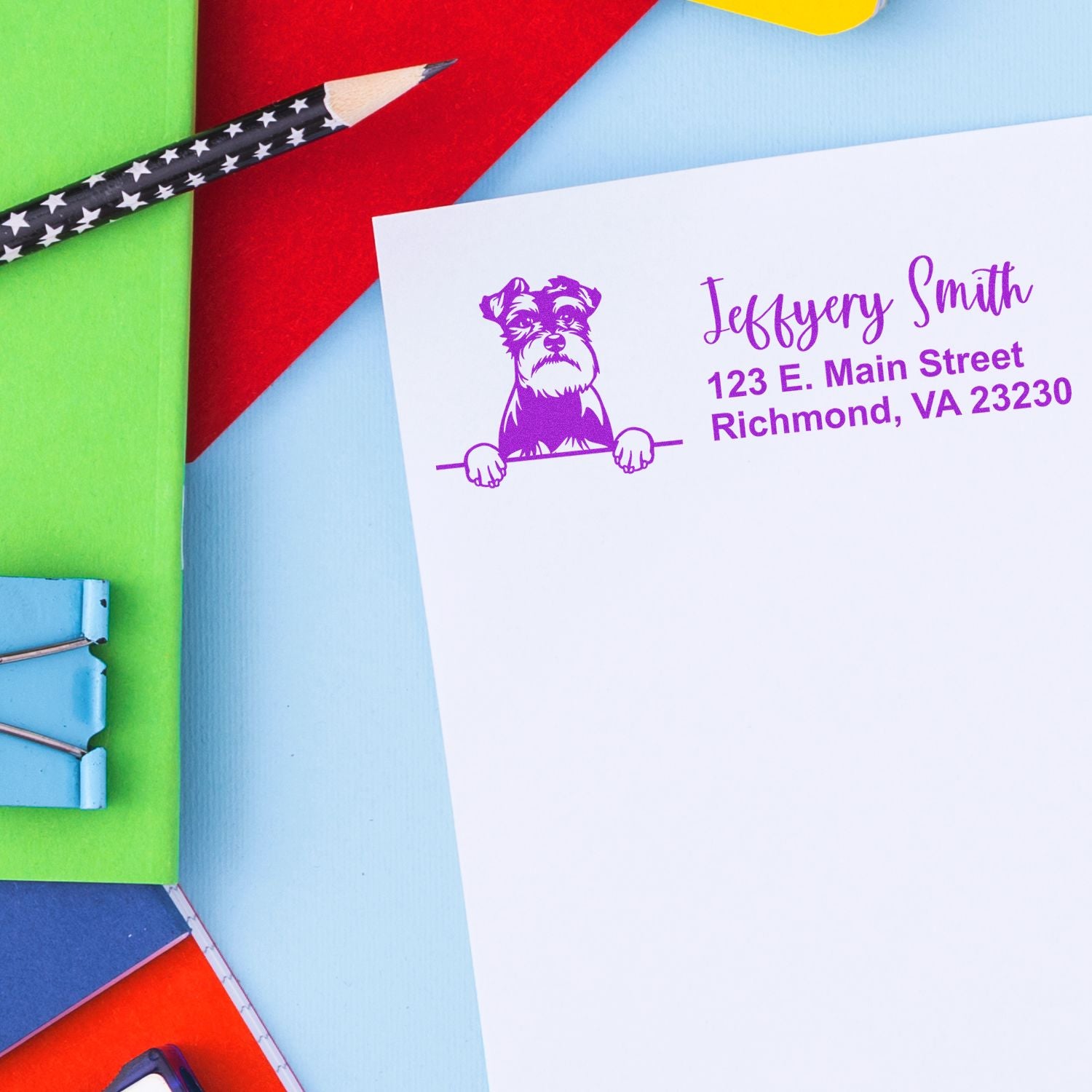 Custom dog logo return address rubber stamp on envelope with purple ink, showcasing personalized mailing stationery.