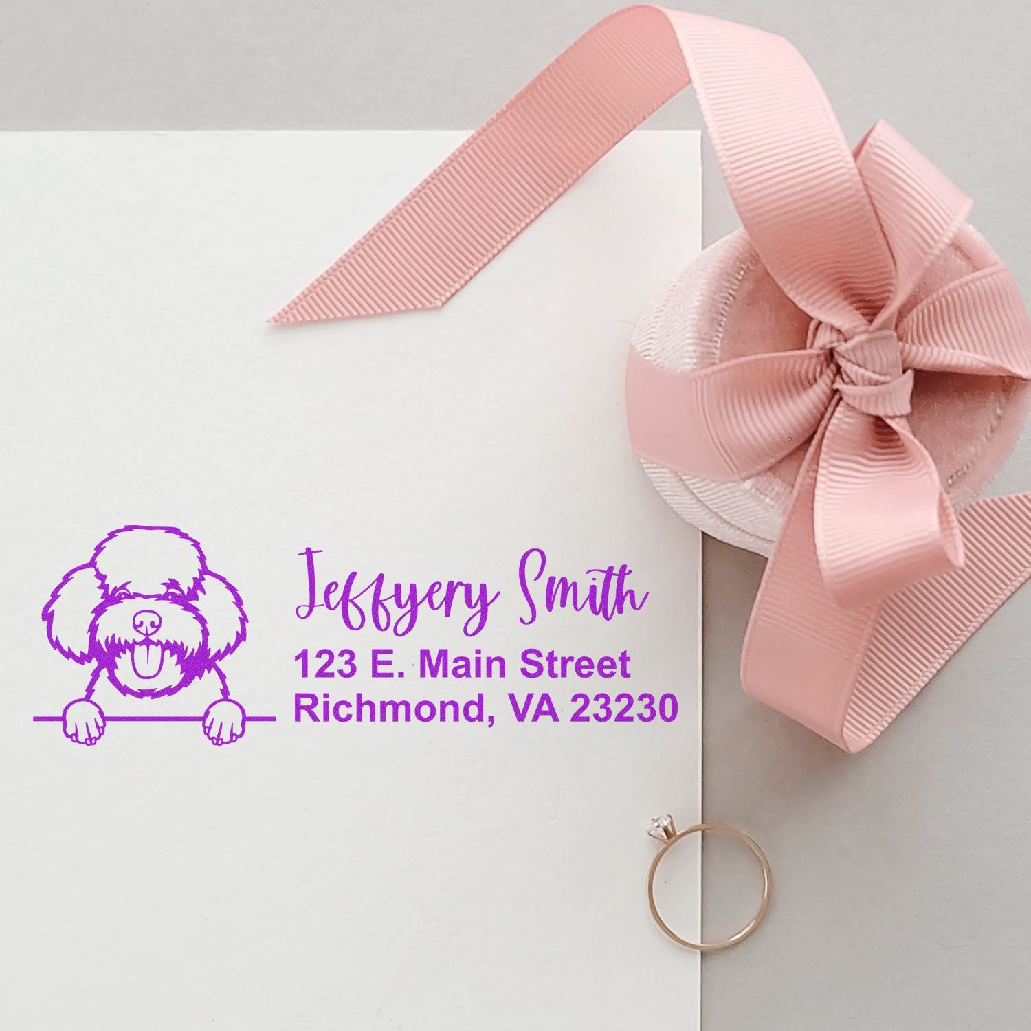 Custom dog return address rubber stamp on white stationery with pink ribbon bow and Richmond, VA address.