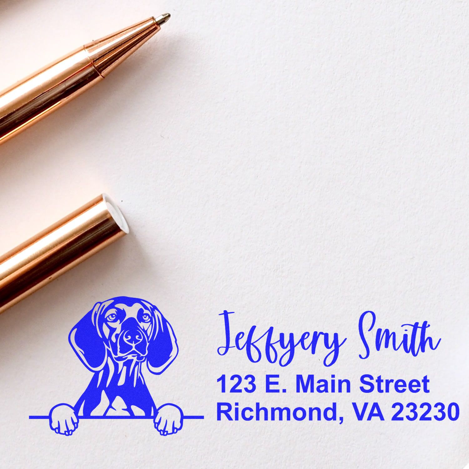 Custom dog address rubber stamp with name and Richmond, VA return address on paper, shown beside a pen.