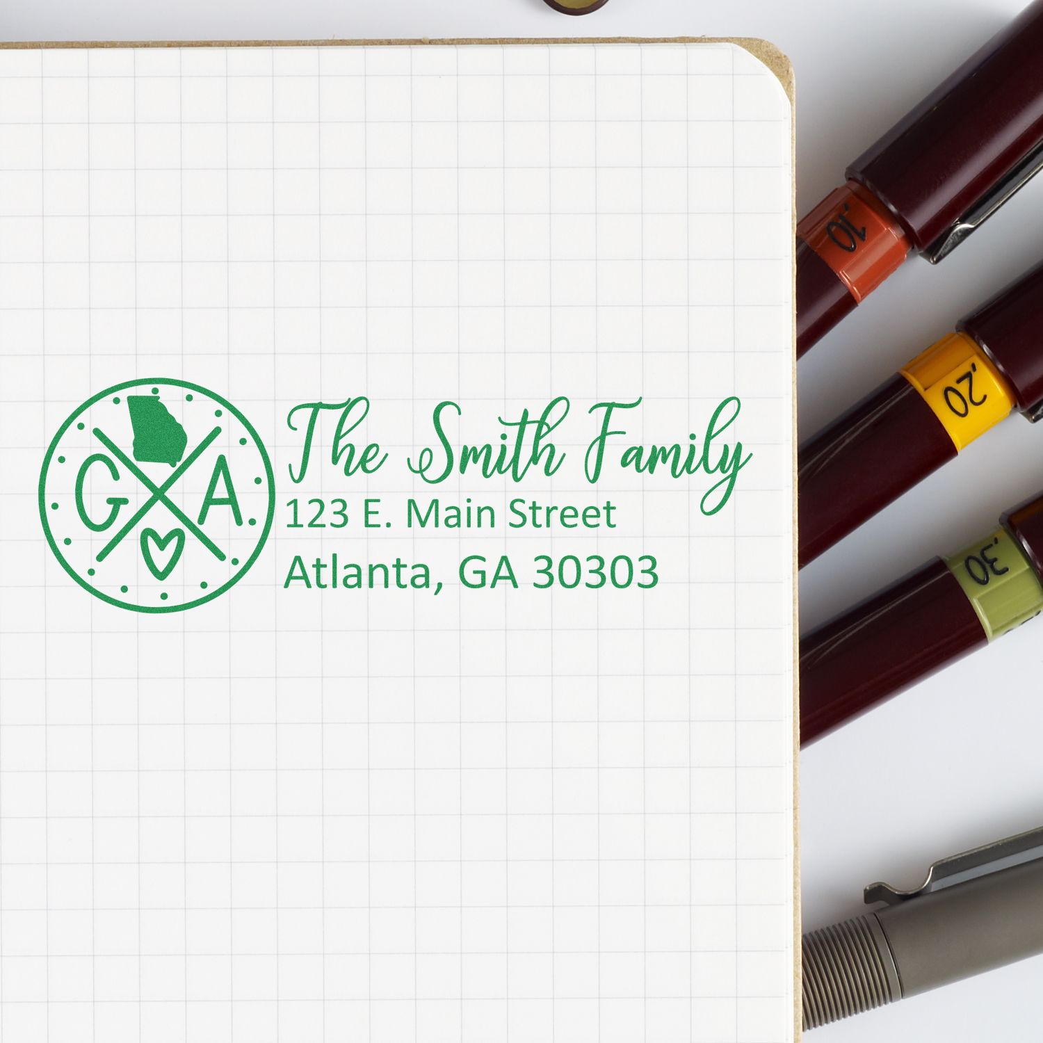Custom family address rubber stamp with monogram logo, The Smith Family, and Atlanta address for personalized stationery.