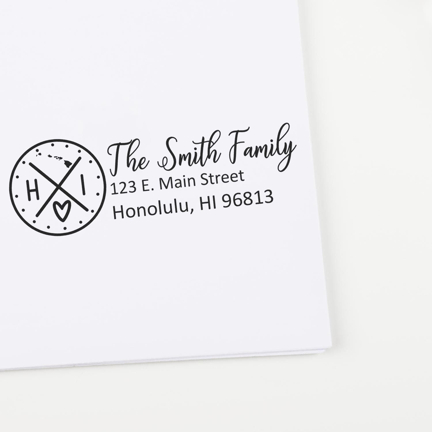 Custom family address rubber stamp with monogram logo and Honolulu, HI mailing address for personalized envelopes and cards.
