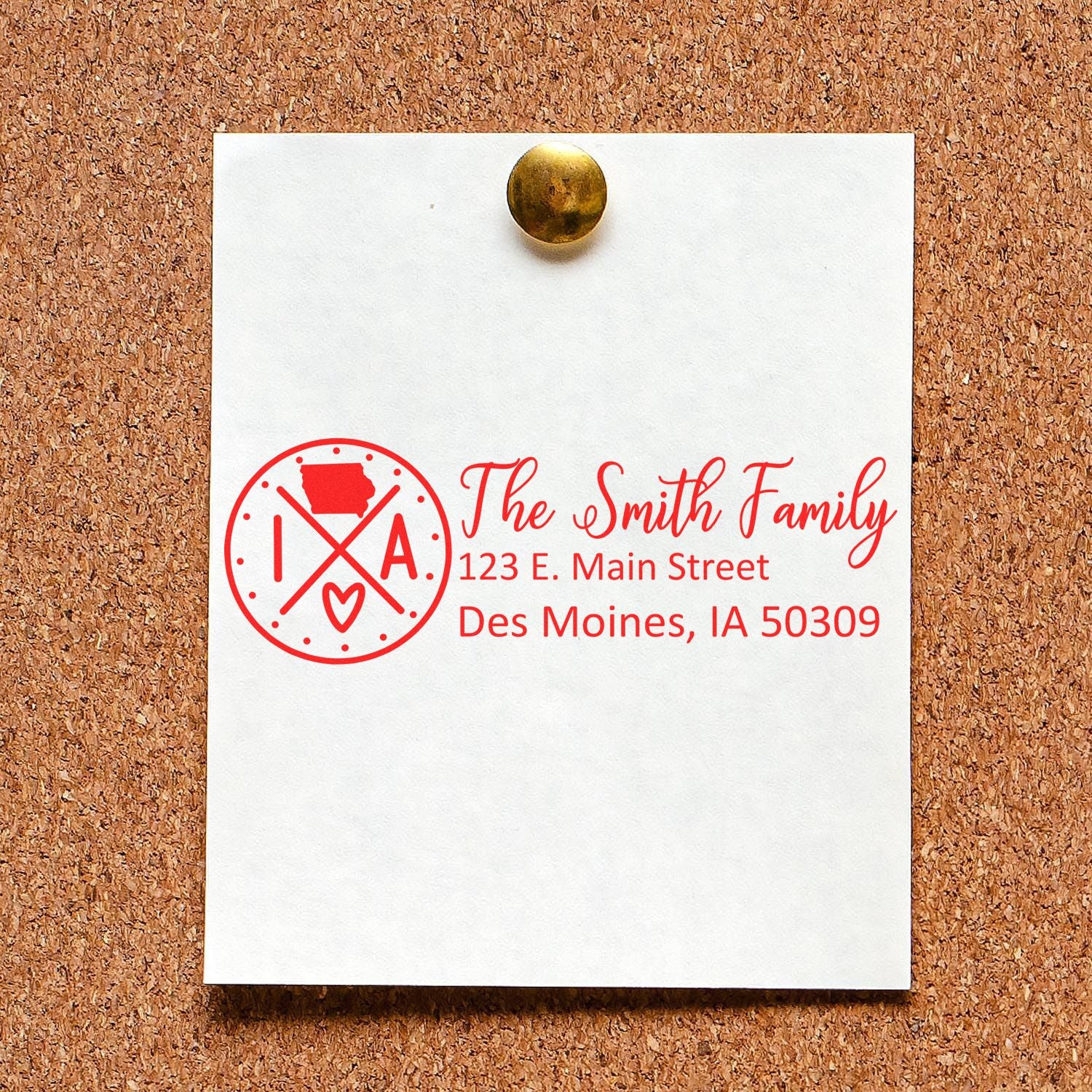 Custom rubber return address stamp with family name, Iowa monogram, and personalized mailing address on a pinned note.