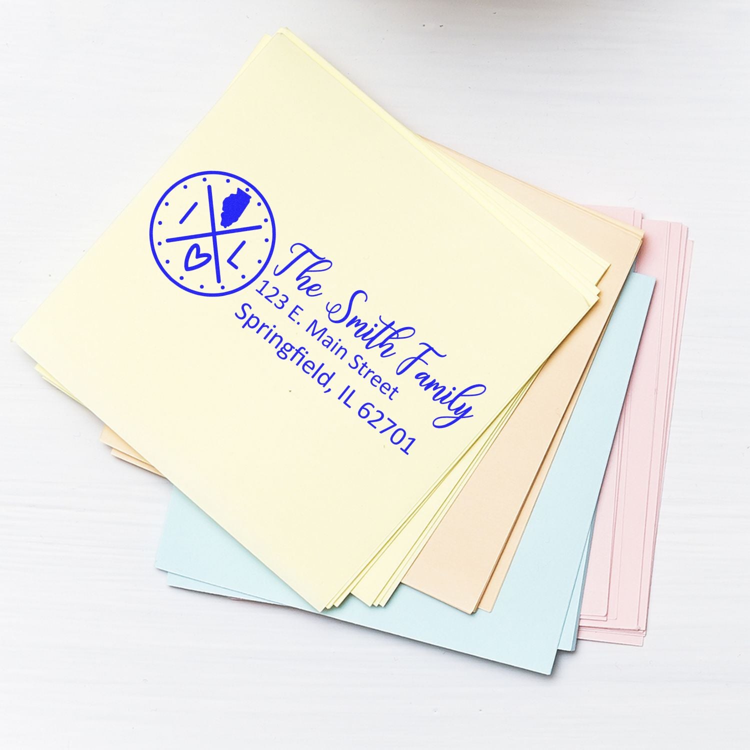 Custom personalized return address rubber stamp on pastel envelopes for The Smith Family, Springfield, IL.