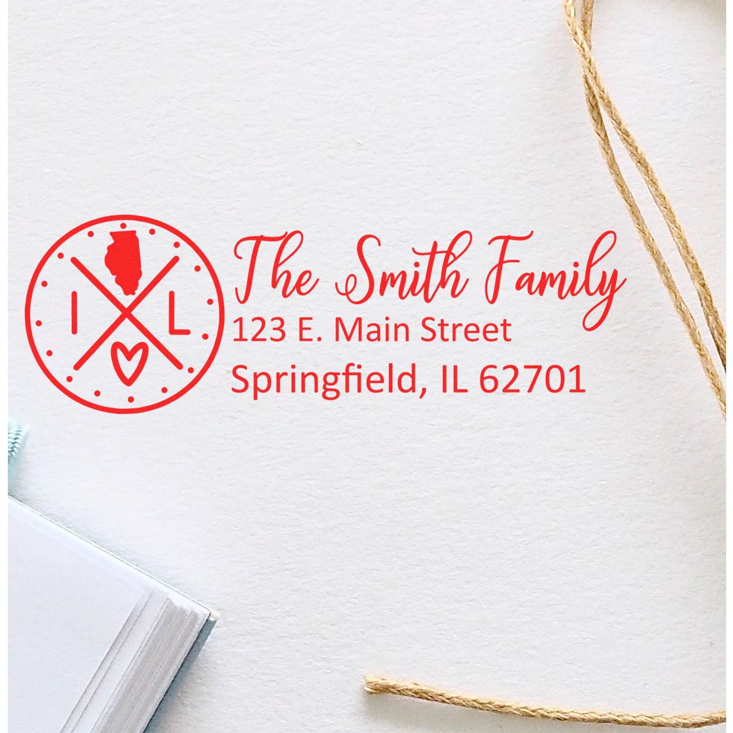 Red custom return address rubber stamp for The Smith Family, with monogram logo and Springfield, IL address.