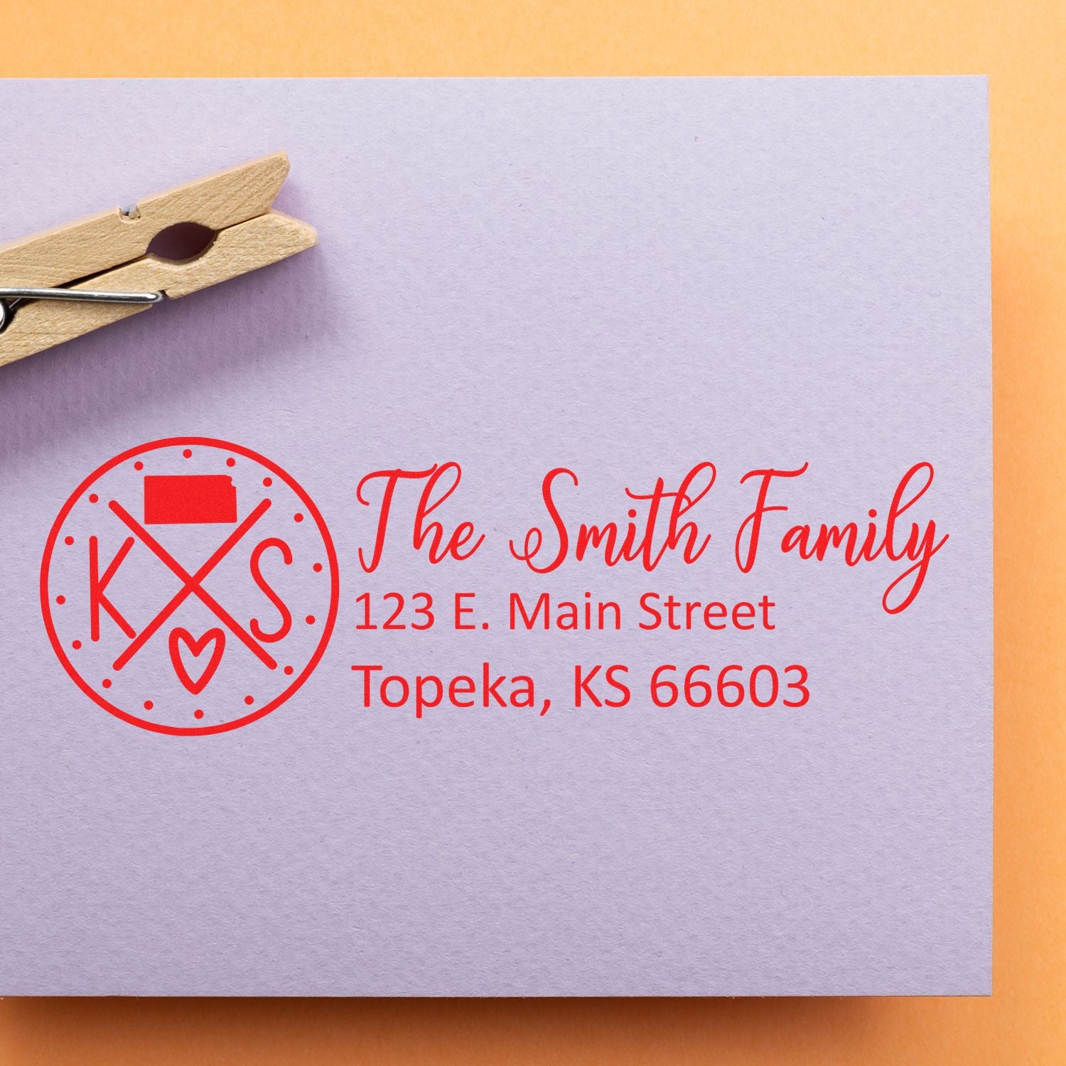Custom rubber return address stamp for The Smith Family, with monogram and Topeka, KS address in red ink.