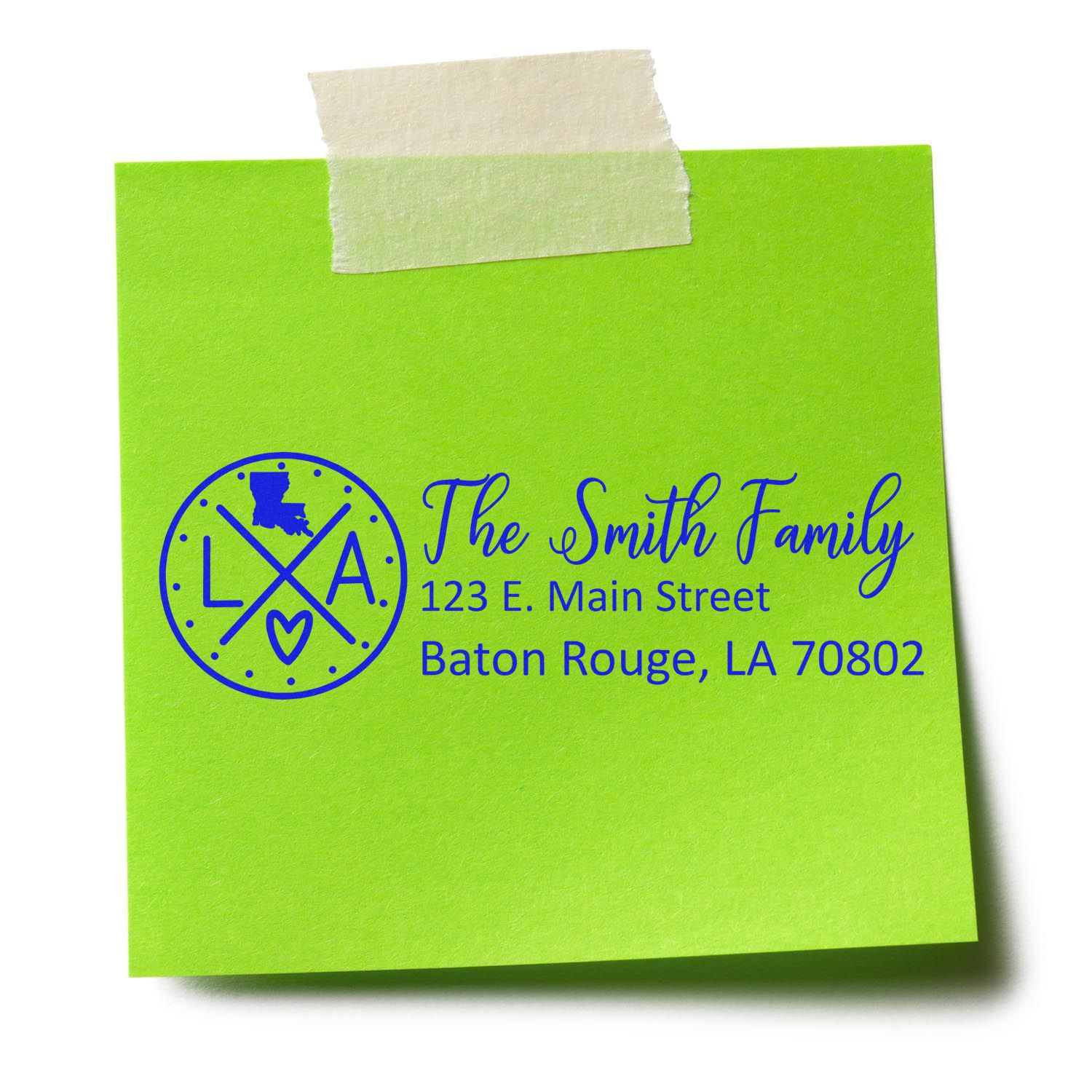 Personalized return address rubber stamp on green sticky note with custom family name, street address, and Baton Rouge, LA.