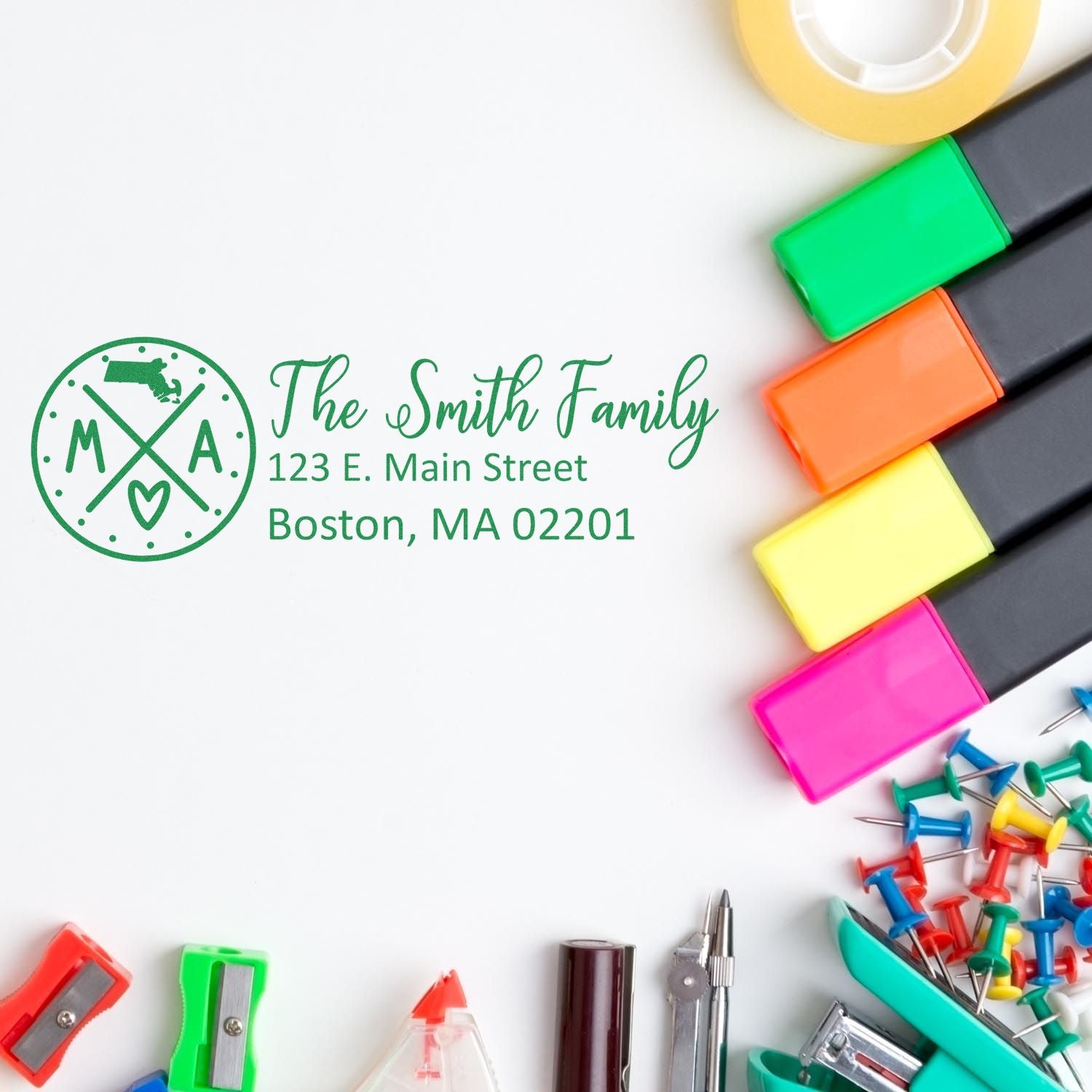 Custom address rubber stamp design for The Smith Family, Boston, MA, shown with colorful office supplies and ink pads.