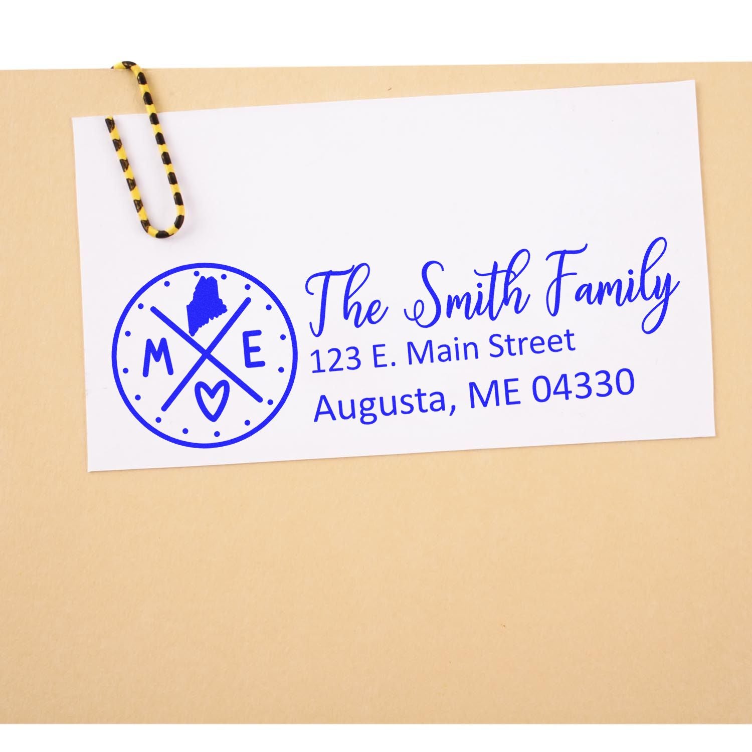 Personalized rubber stamp for family return address, showing monogram, name, and Augusta, Maine address on a clipped card.