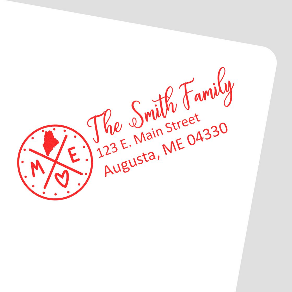 Custom return address rubber stamp for The Smith Family, Augusta, ME, with Maine state icon and heart design.