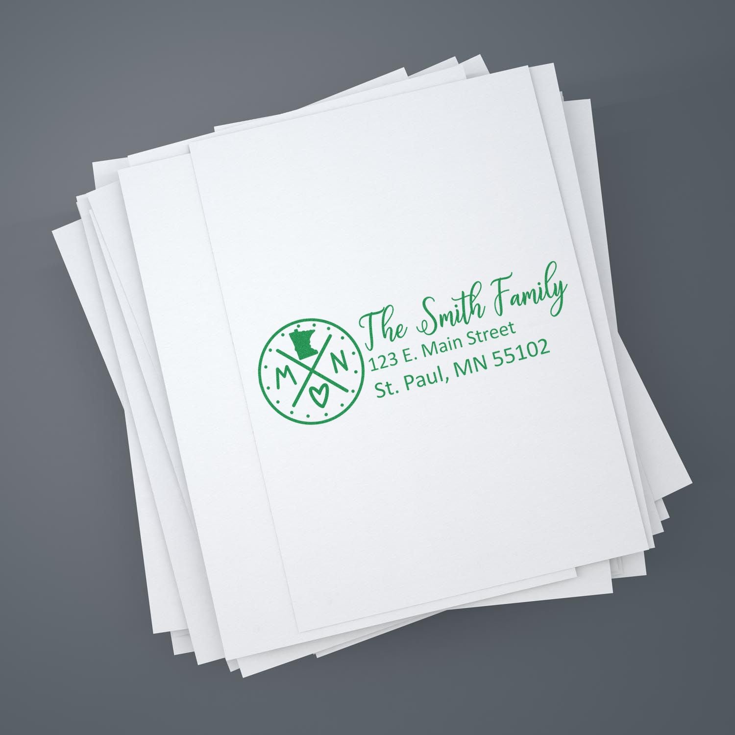 Custom family return address rubber stamp sample on white stationery, with green ink for envelopes and mailings.