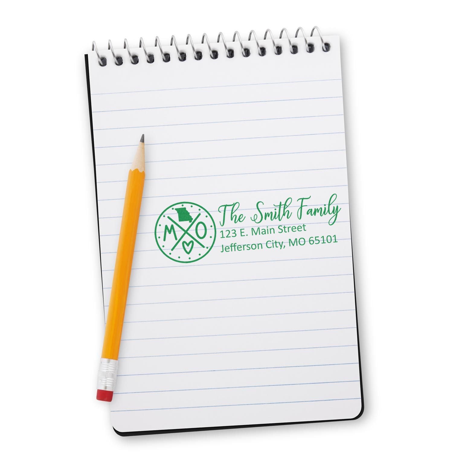 Personalized address rubber stamp on notebook with pencil, featuring family monogram and Jefferson City, MO address.