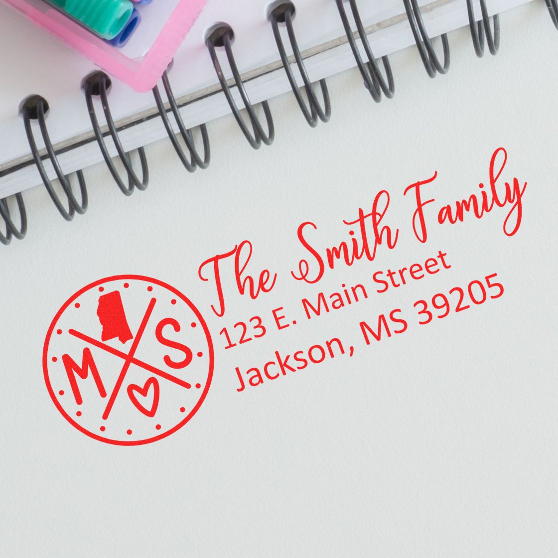 Custom family return address rubber stamp with monogram for The Smith Family, 123 E. Main Street, Jackson, MS 39205.
