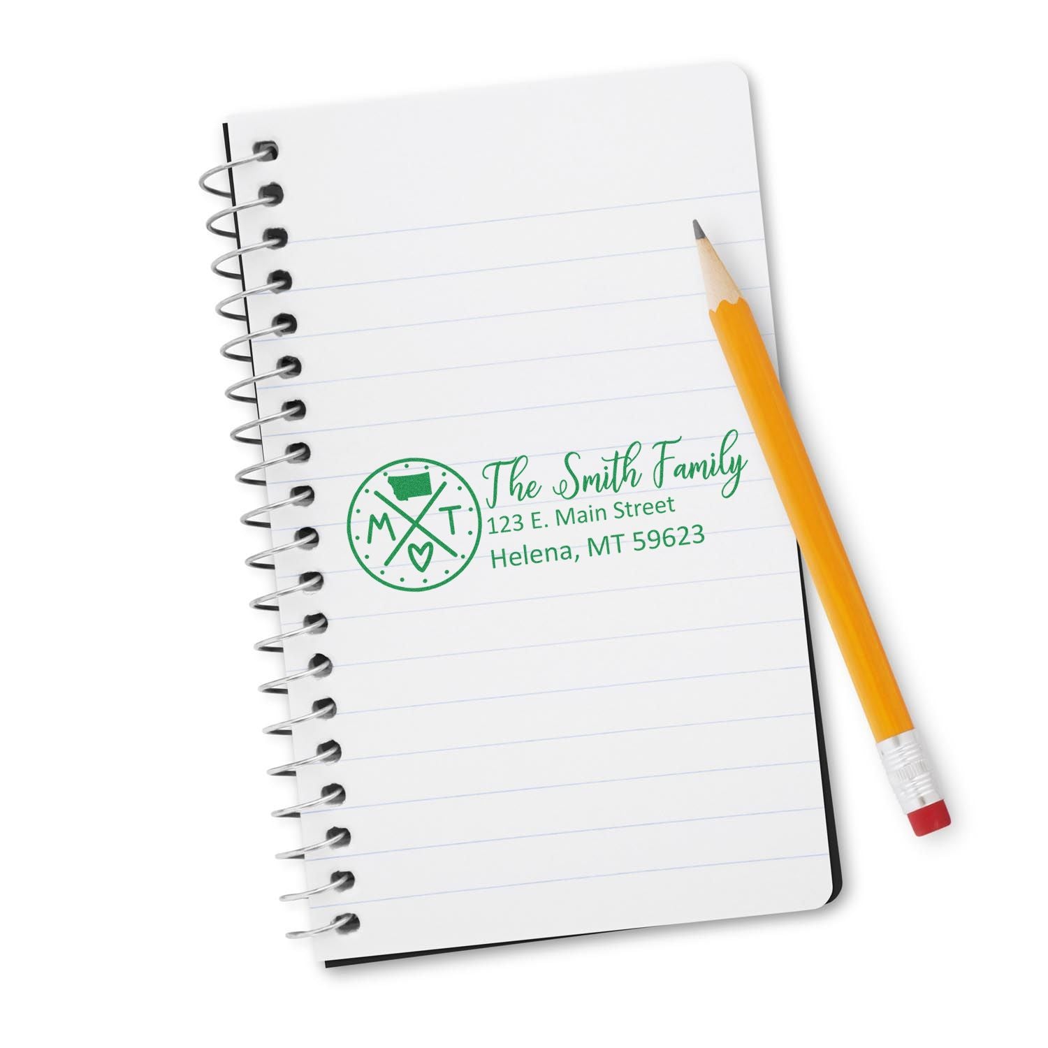 Custom family return address rubber stamp on notebook, ideal for personalized stationery and mailings.