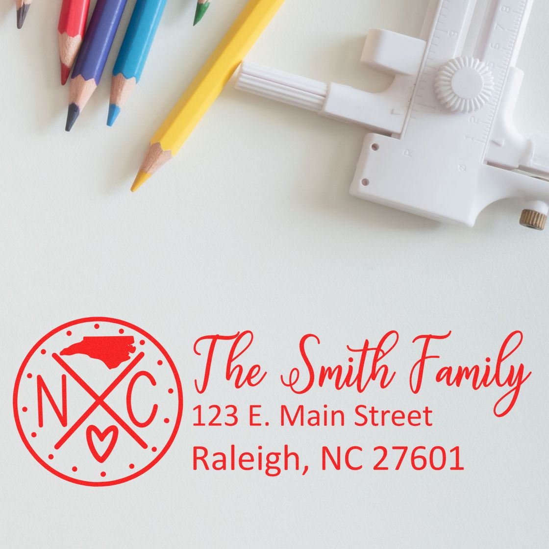 Custom return address rubber stamp for The Smith Family, Raleigh, NC 27601, with personalized monogram logo.