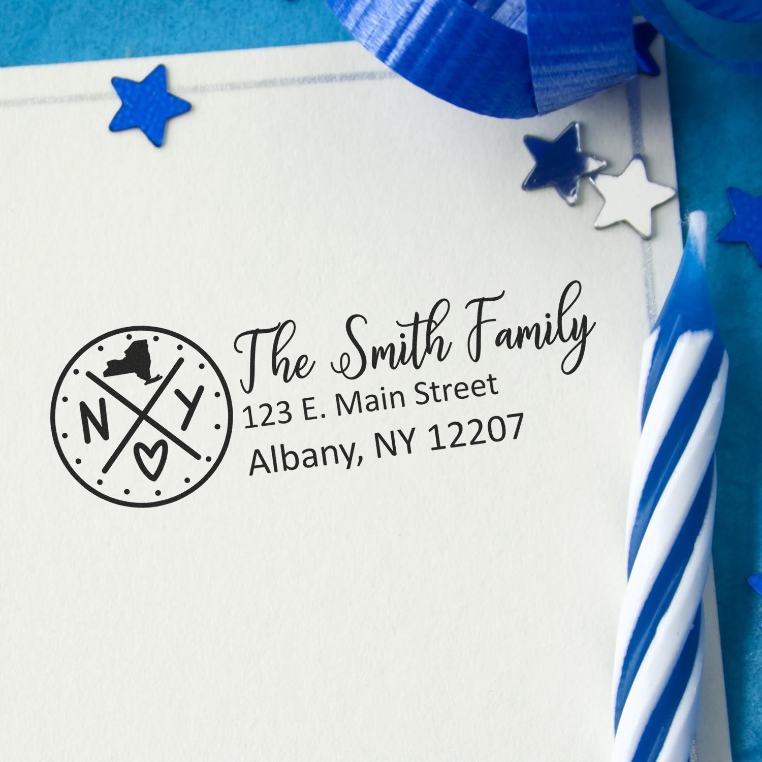 Custom rubber return address stamp for The Smith Family in Albany, NY, featuring a New York monogram and stars.
