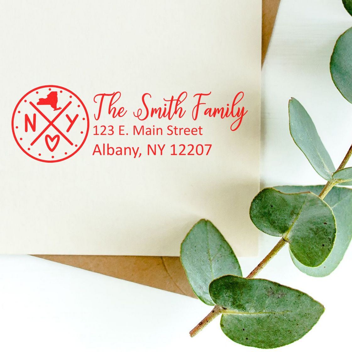 Personalized return address rubber stamp for The Smith Family with name, address, and Albany, NY 12207 on an envelope.