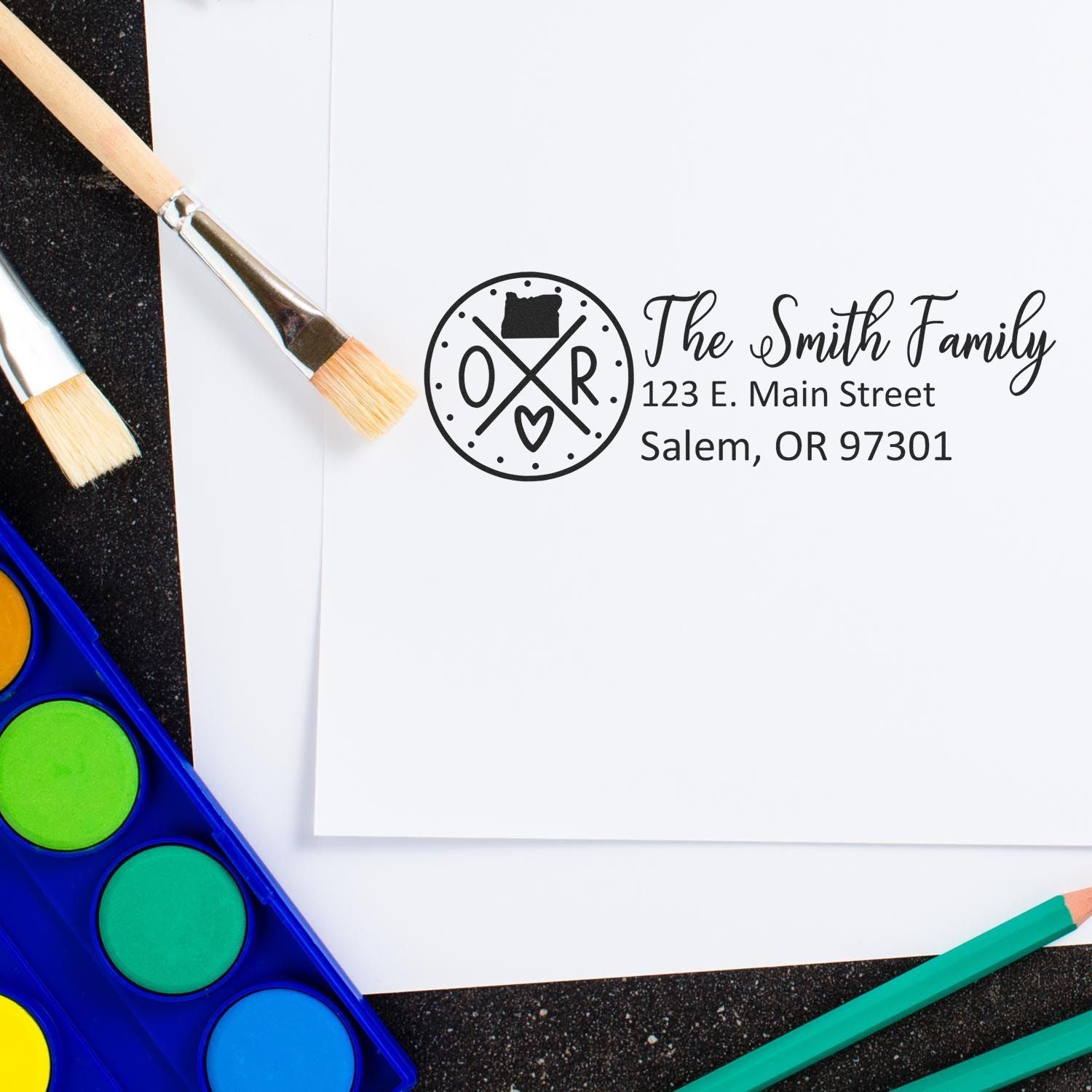 Personalized family address rubber stamp with custom name, street address, and city for stationery or return mail.