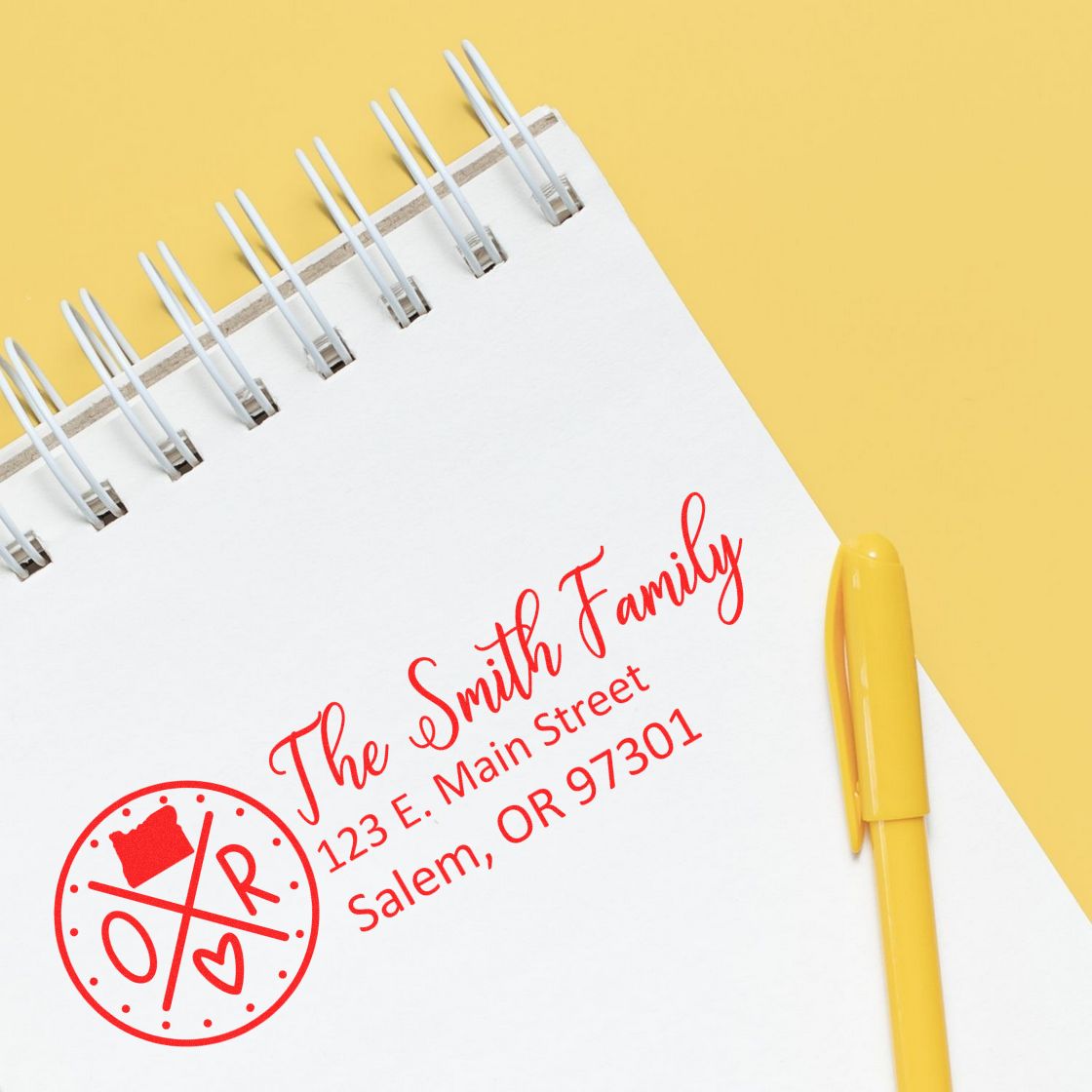 Custom rubber address stamp for The Smith Family with return address, showcasing a personalized family stamp design on a notebook.