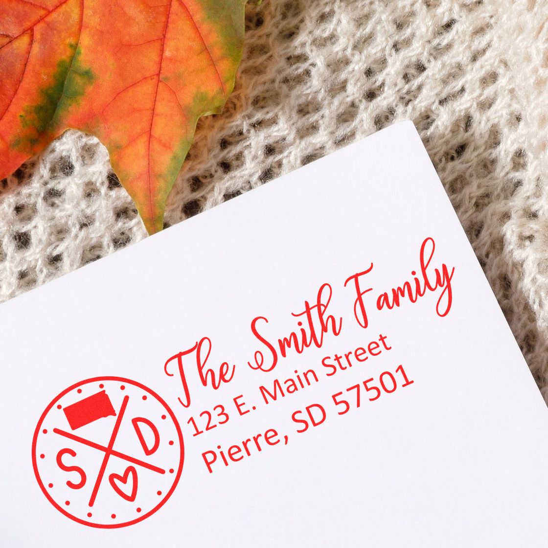 Custom family return address rubber stamp with monogram and red ink, perfect for wedding invitations, mail, and stationery.