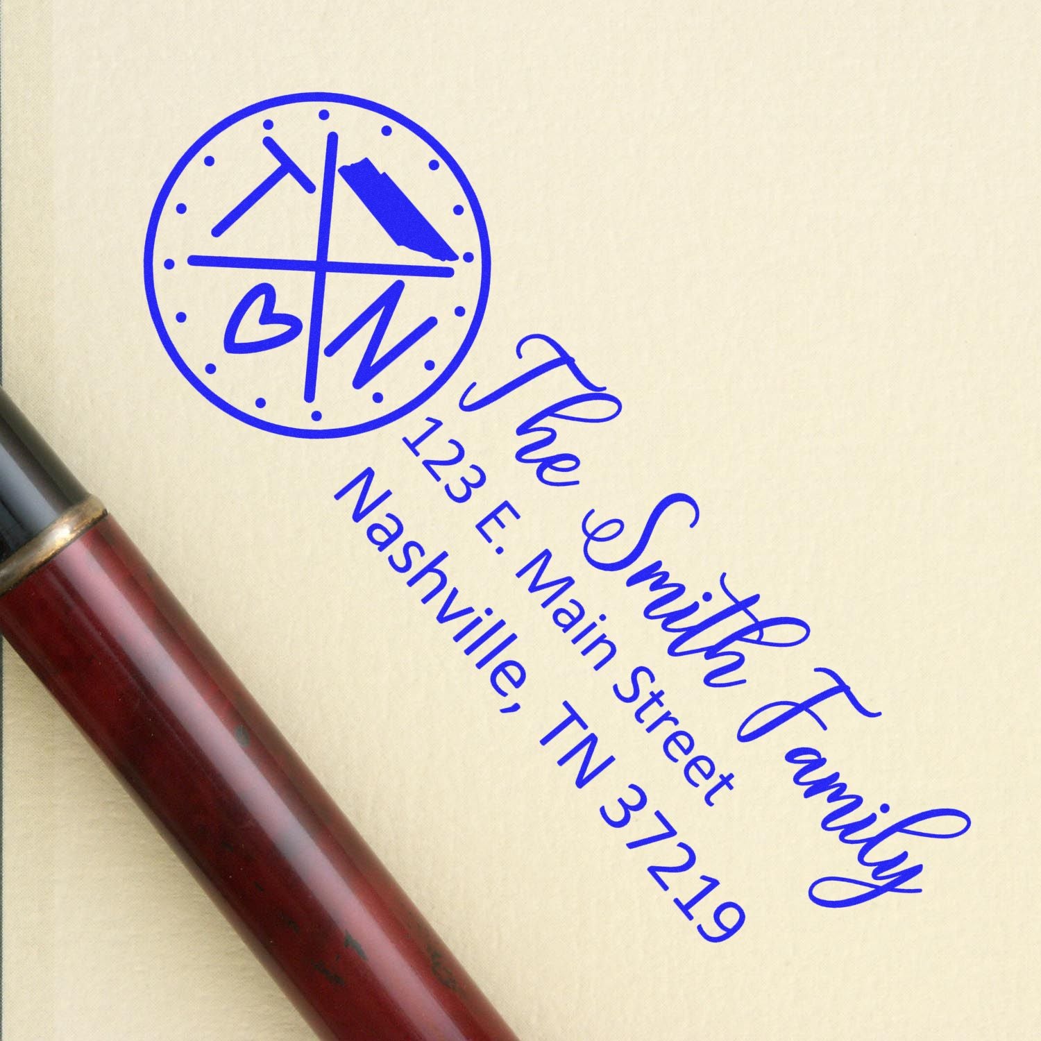 Custom return address rubber stamp for The Smith Family, 123 E. Main Street, Nashville, TN 37219, with blue ink impression.