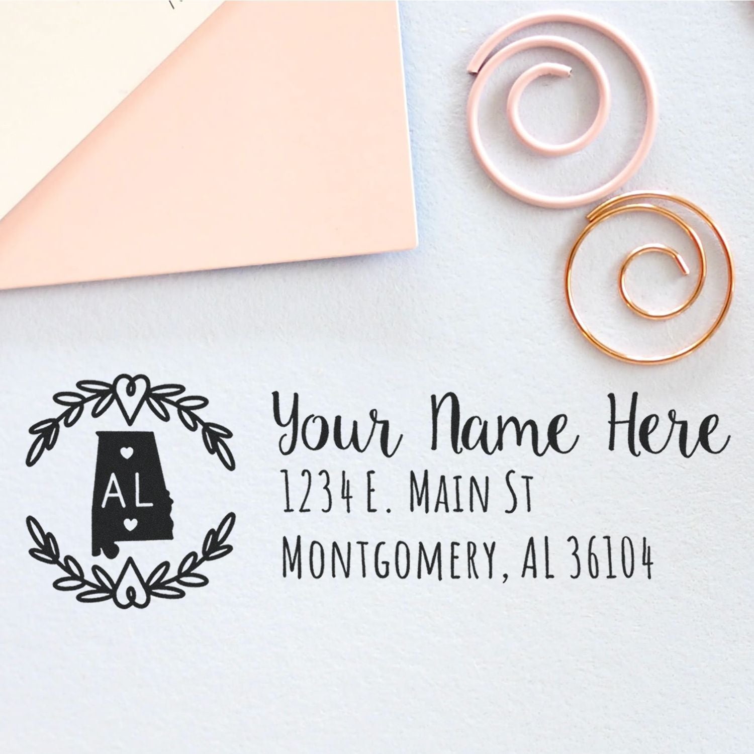 Custom Alabama return address rubber stamp with floral wreath, name, and address for stationery.