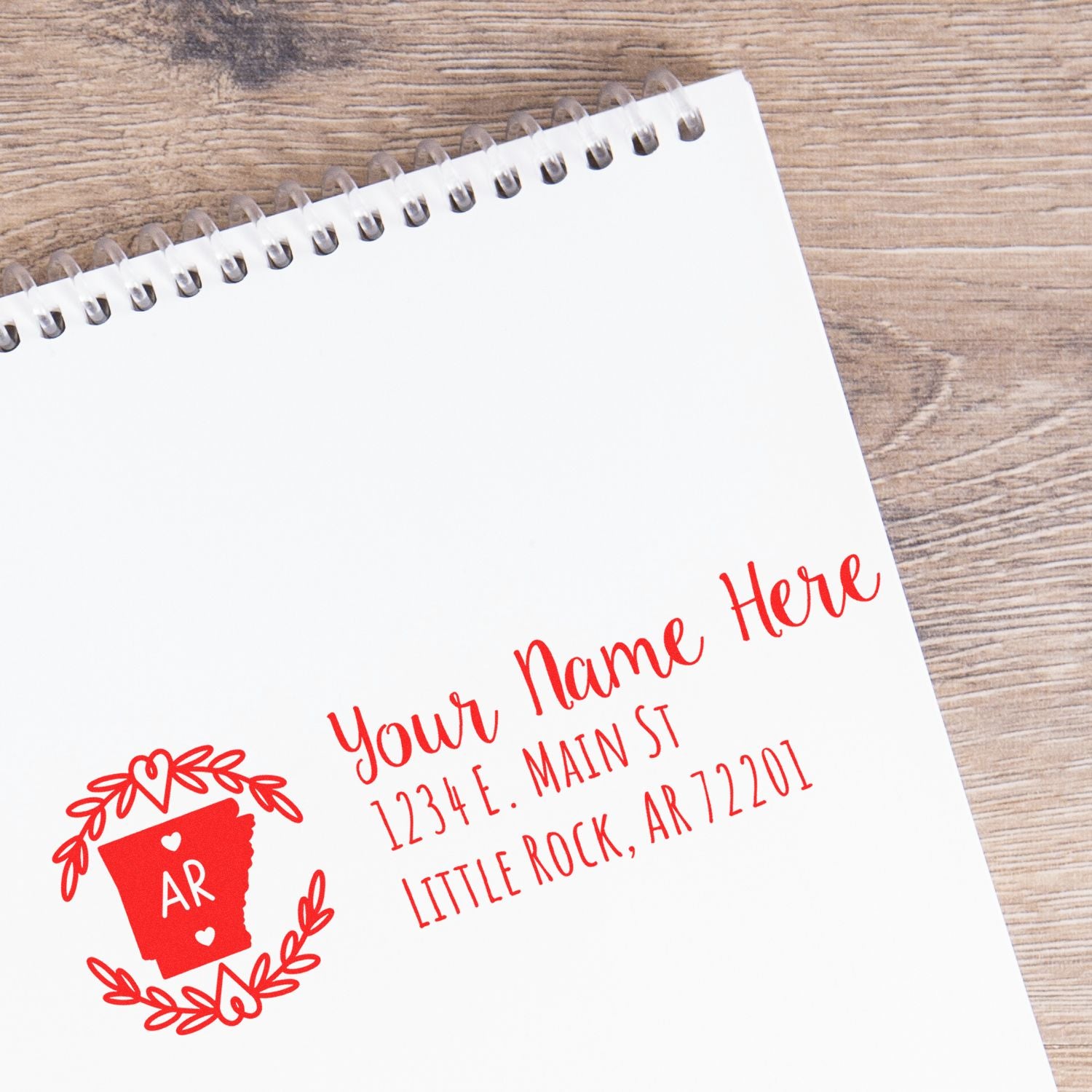Personalized rubber address stamp with Arkansas state design and custom return address imprint in red.
