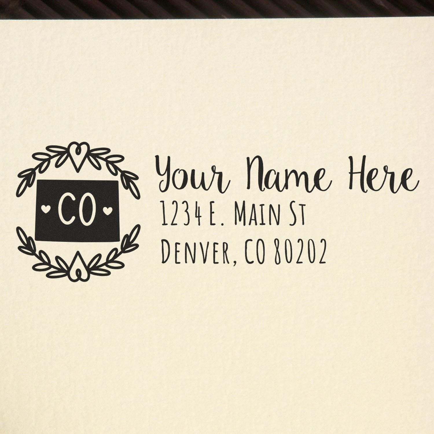 Custom rubber stamp return address design with floral wreath, Colorado monogram, and personalized Denver, CO mailing address.