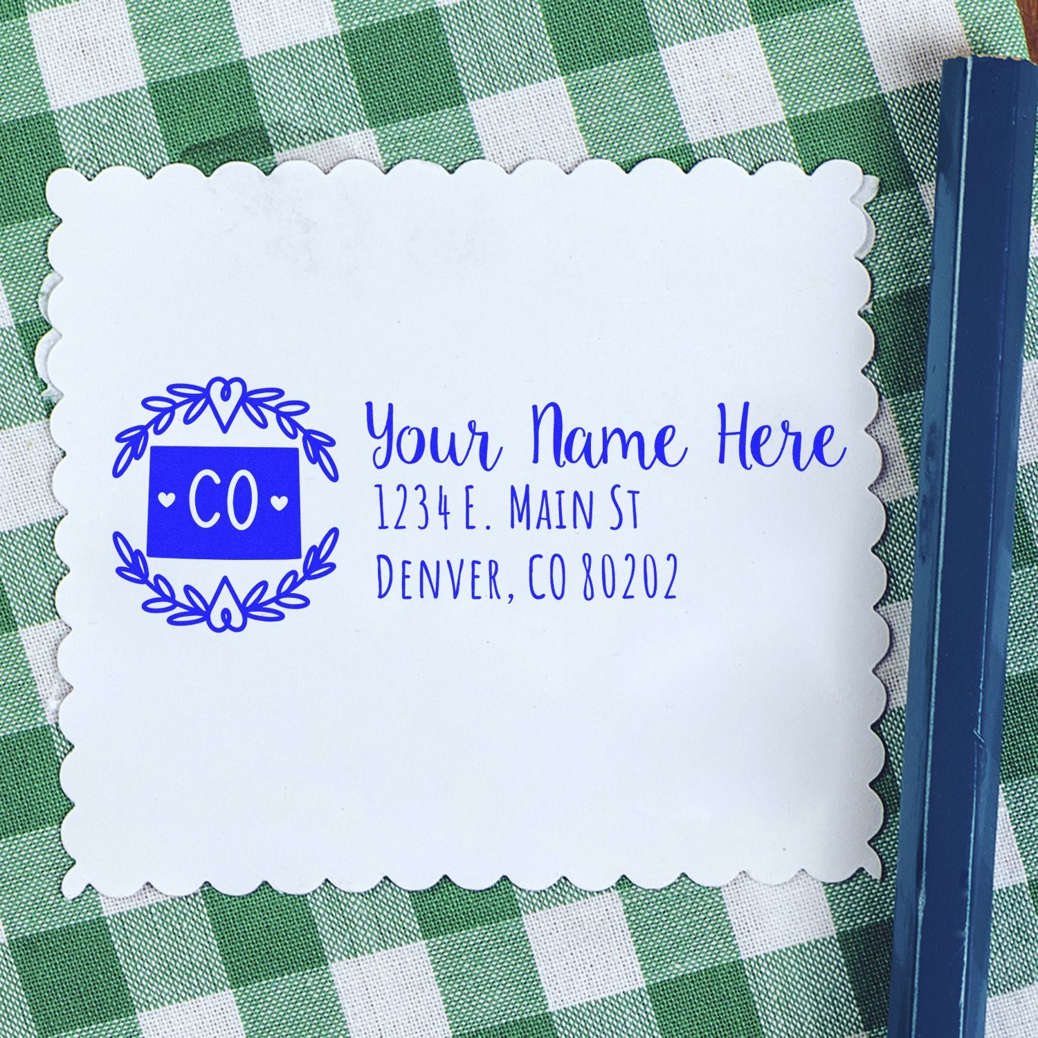 Custom Colorado return address rubber stamp with name, street address, and Denver, CO ZIP code on white paper.