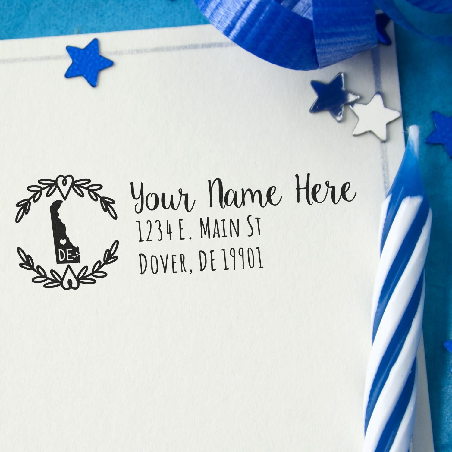 Personalized Delaware return address rubber stamp with laurel design, name, street address and city on white card.