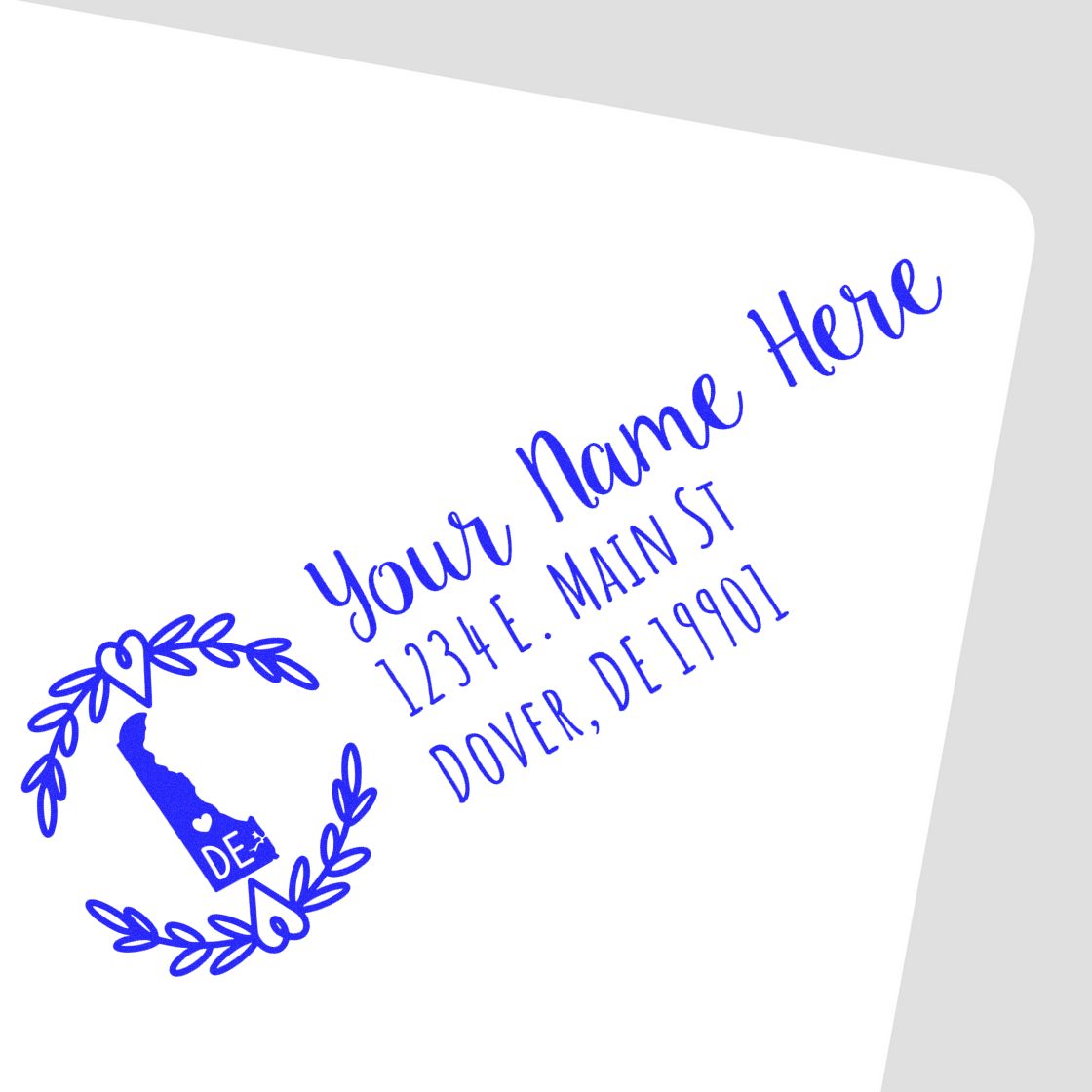 Custom return address rubber stamp with Delaware state design, wreath and sample name for personalized mailing labels.