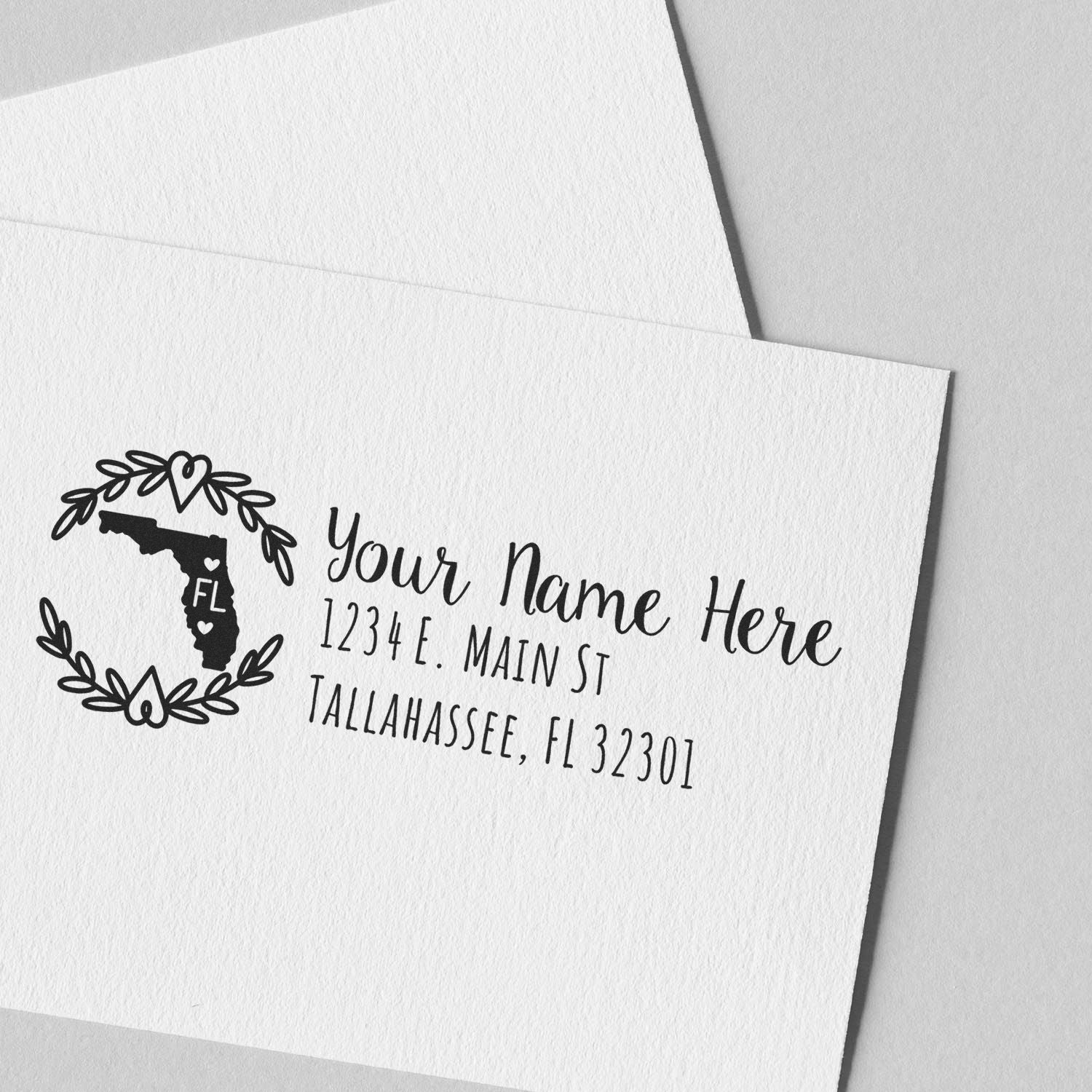 Custom rubber return address stamp with Florida state design and leafy wreath for personalized envelopes and mail.