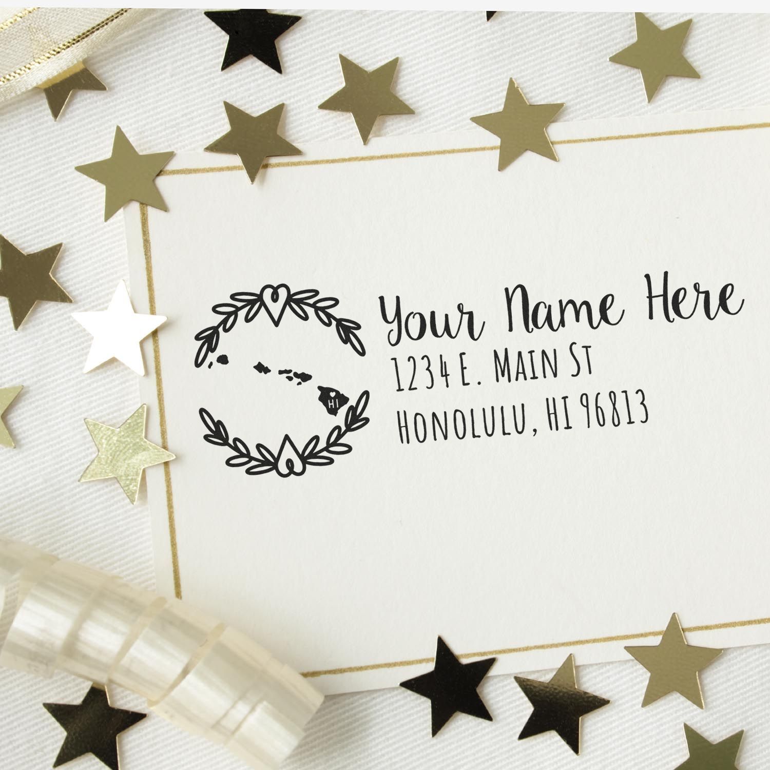 Custom Hawaii return address rubber stamp with floral wreath design on a white envelope.