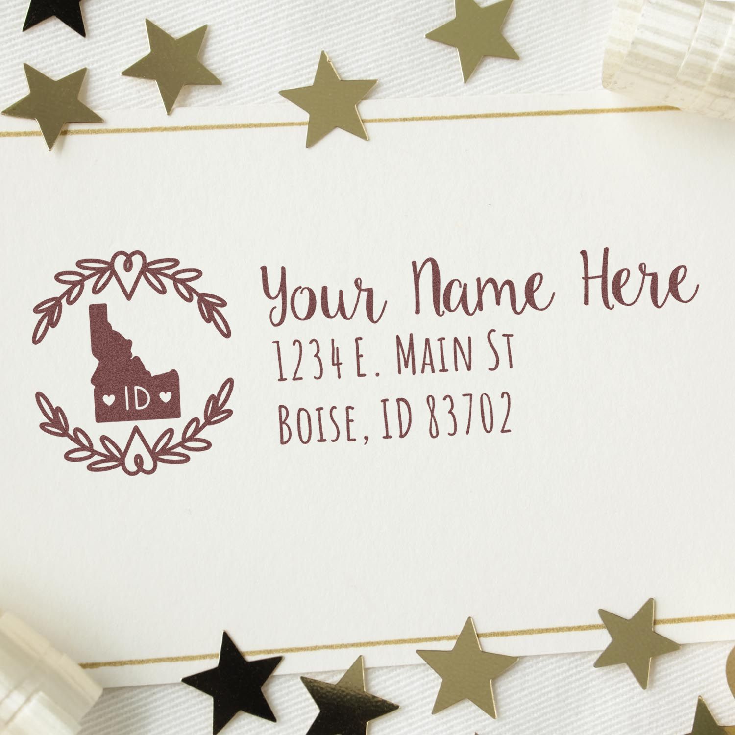 Custom Idaho return address rubber stamp with state silhouette, laurel wreath, and personalized name and Boise, ID address.