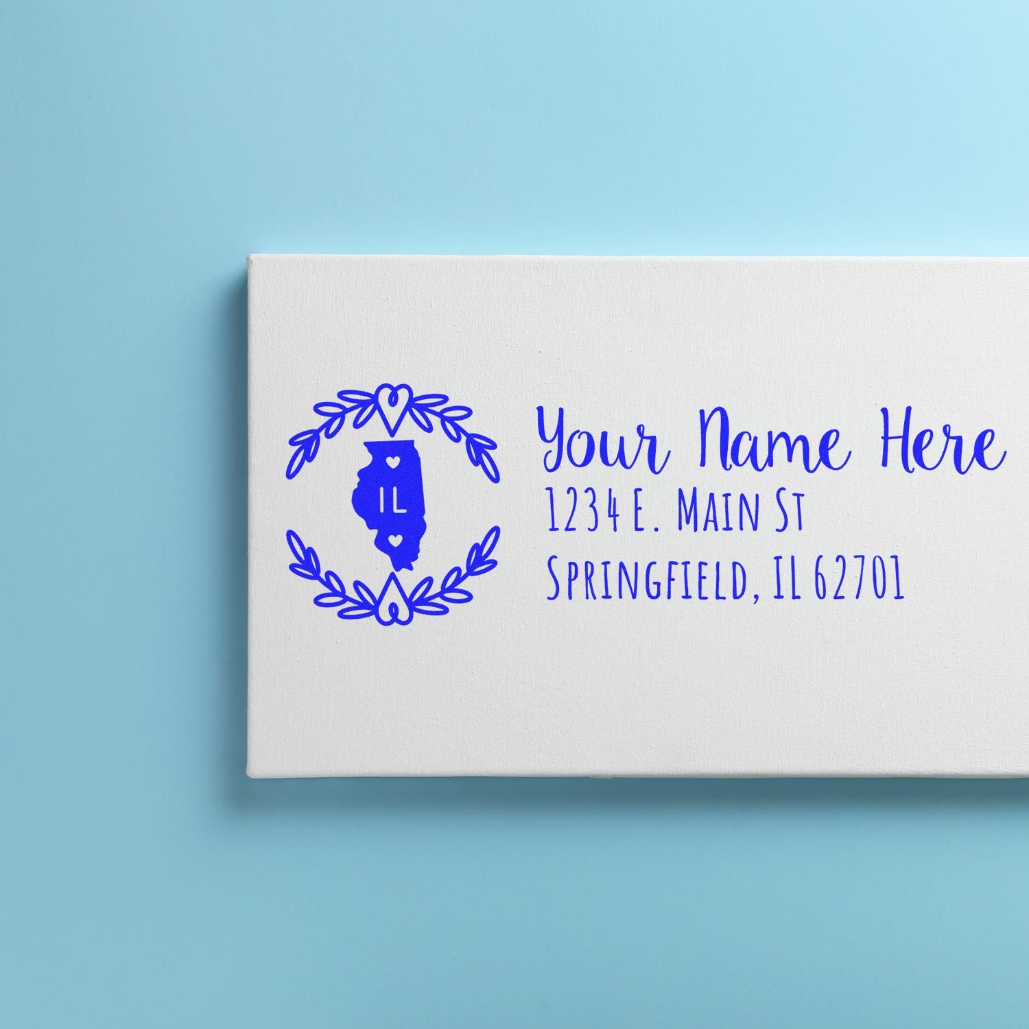 Custom Illinois return address rubber stamp for address labels, featuring a floral wreath and state outline in blue ink.