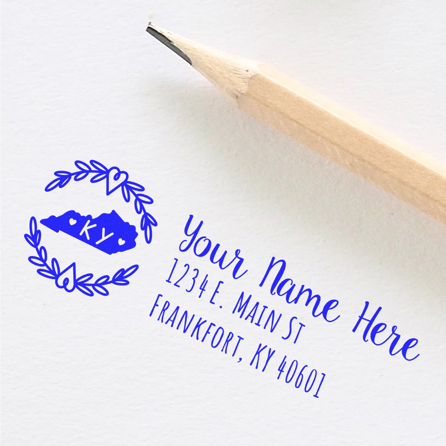 Personalized return address rubber stamp with laurel wreath design and Kentucky address sample for envelopes and mailing.